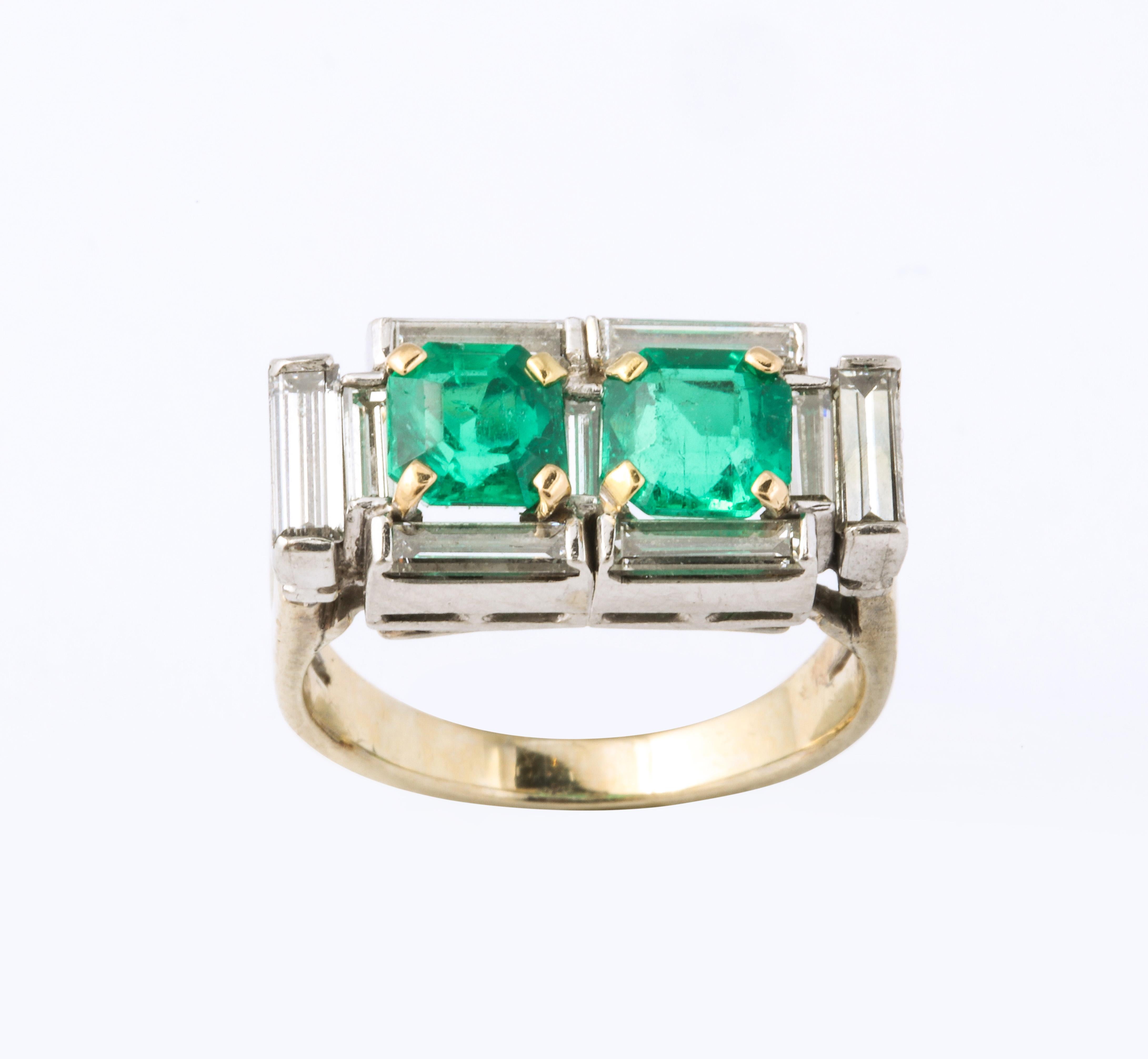 A stunning French Art Deco 2 stone emerald ring with a set of baguette cut diamonds accents  in a platinum and white gold setting. With appraisal