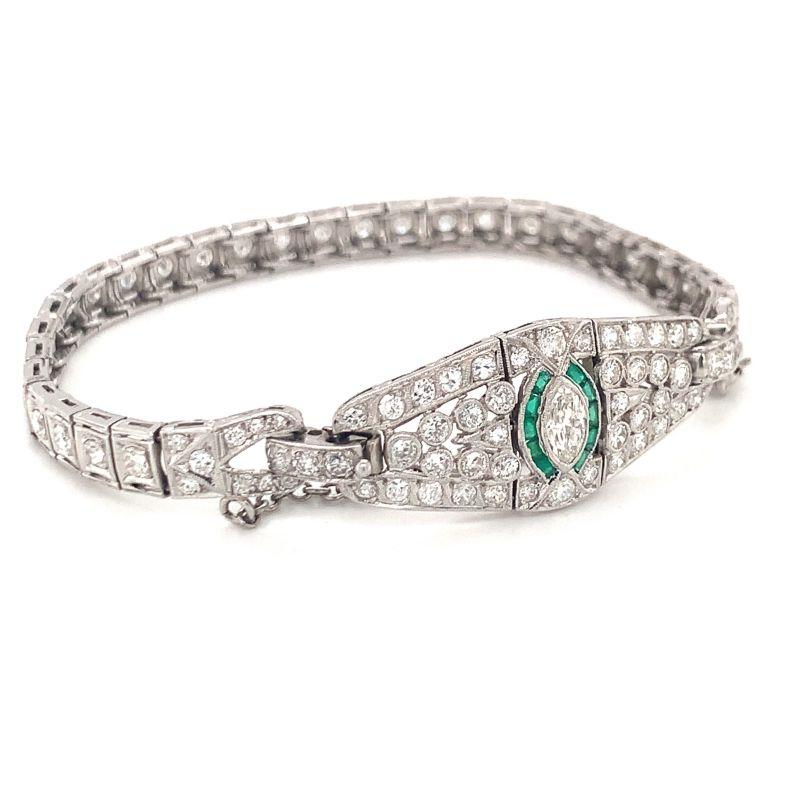 One Art Deco diamond and emerald platinum bracelet featuring 95 marquise, old European cut and transitional round cut diamonds totaling 3.50 ct. with both natural and synthetic emerald accents. Circa 1920s.

Intricate, detailed, vintage.

Additional