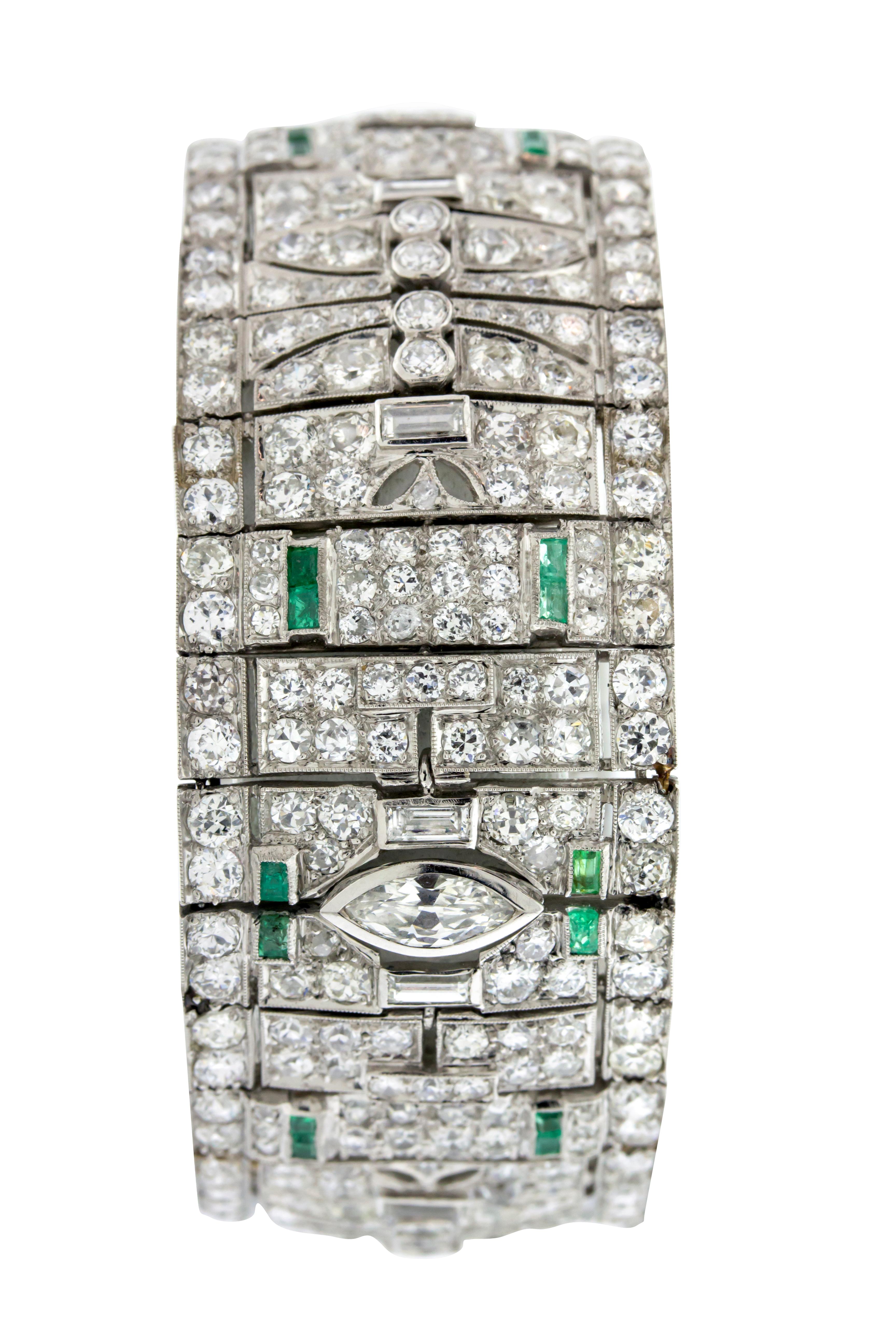 Diamond and Emerald Art Deco style bracelet circa 1930. Approximately 21 carats of mixed cut diamonds, G-H VS-I1, 1 carat emerald set in Platinum. 7 inch length, and 2.5 inches wide with a total weight of 72.8g total weight. Includes GAL