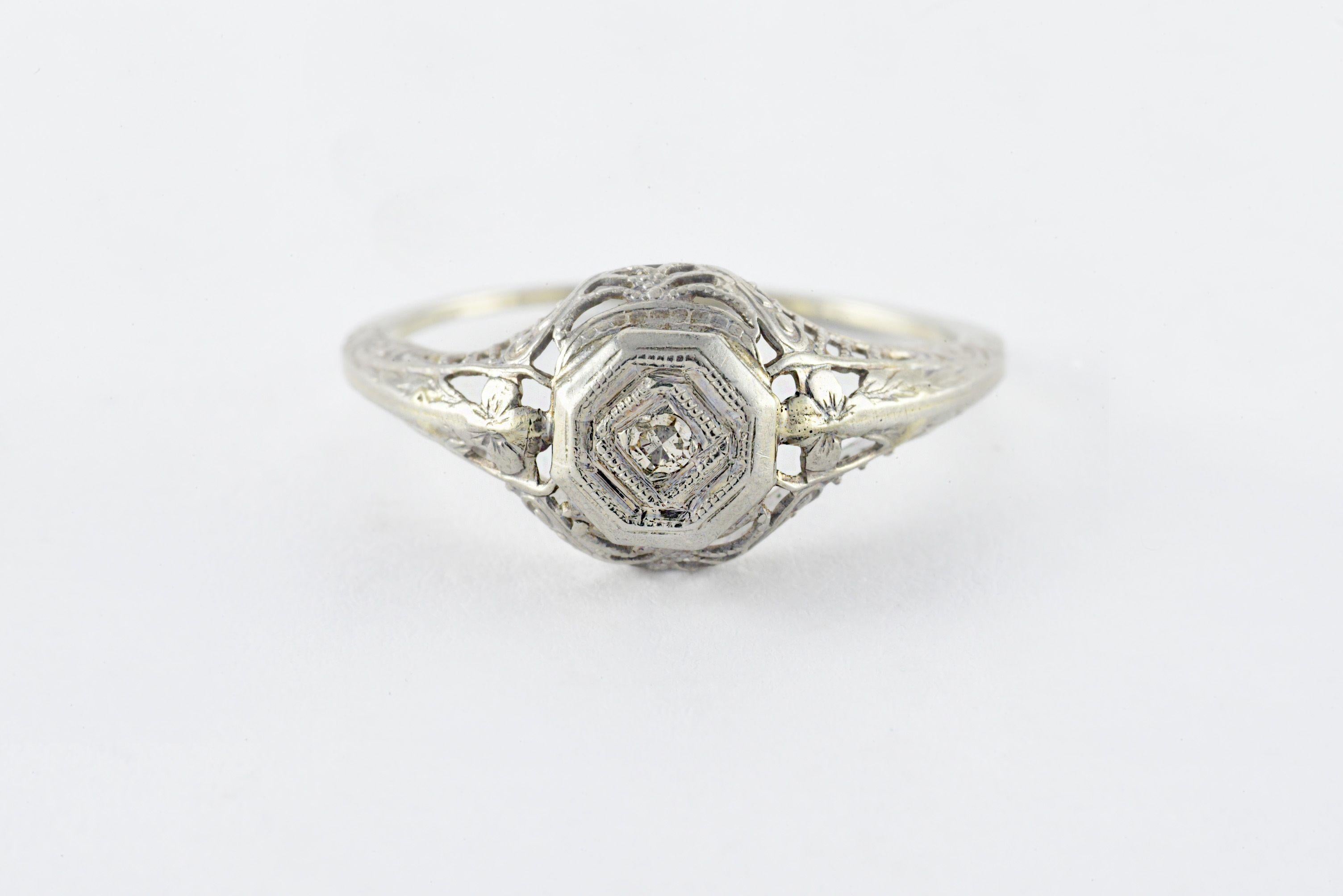 This striking band is meticulously crafted from 18kt white gold with fine filigree details and set with a single cut diamond measuring approximately 0.01 carats. 
