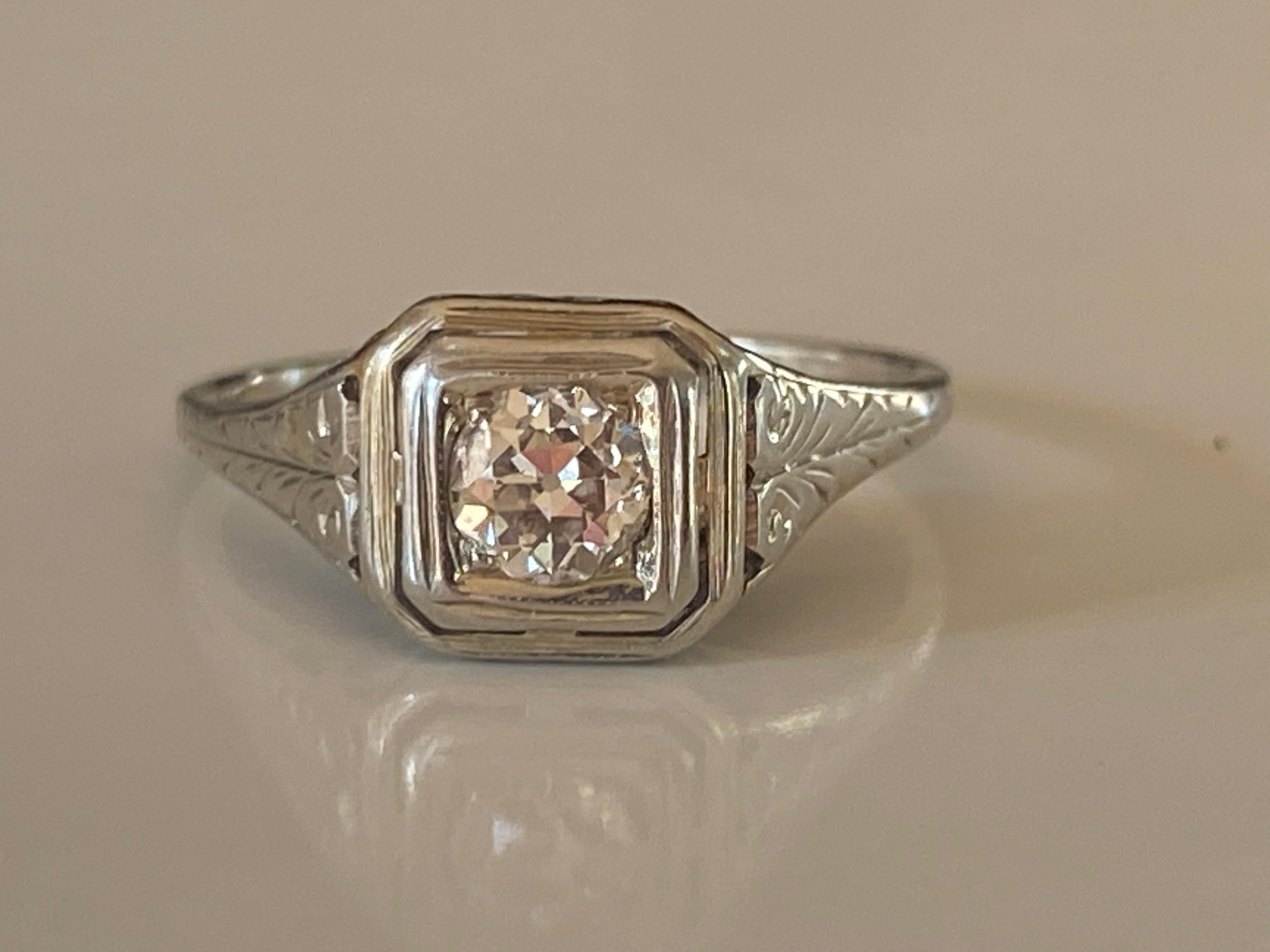 Crafted in the 1930s in 14kt white gold, this striking Art Deco band is set with an Old European cut diamond measuring approximately 0.35 carats, G color, VS clarity and fine filigree details. 
