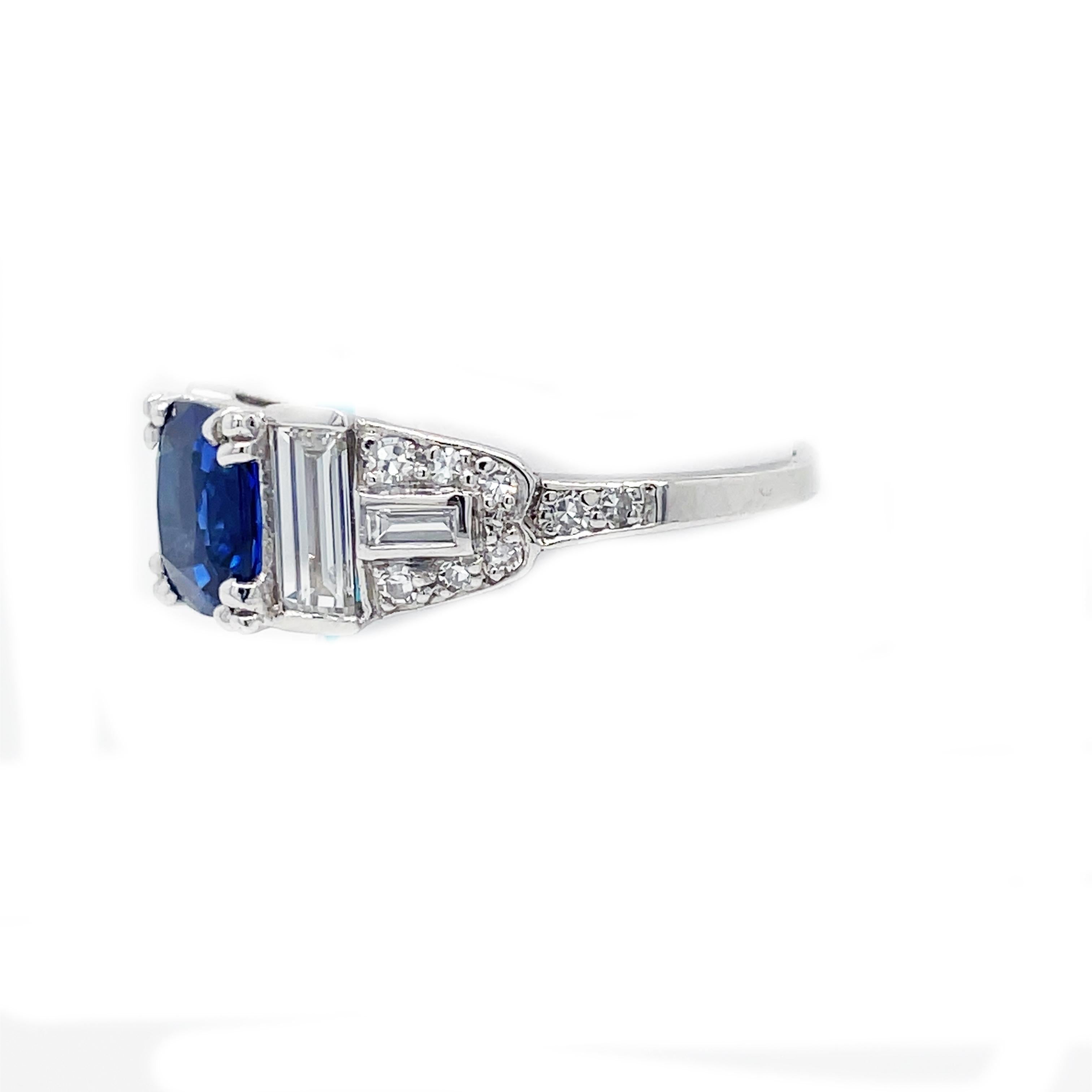 This is an absolutely killer 1940's Art Deco Style ring set in Platinum that features stunning bright white diamonds and an almost 2.00 carat heat only vivid blue sapphire! This is a beautiful example of amazing Art Deco style jewelry! 

Can you