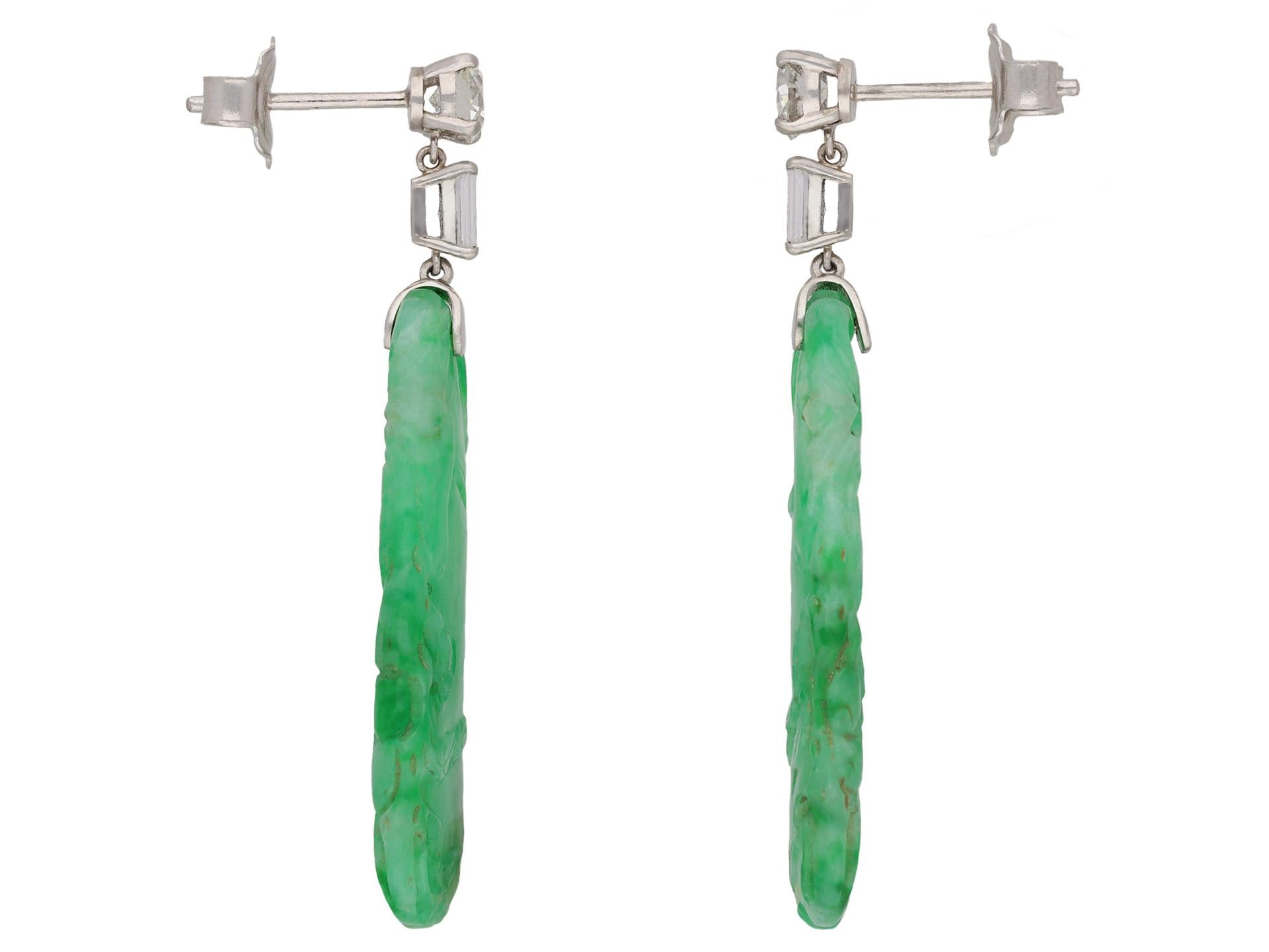 Art Deco diamond and jade earrings. A matching pair of earrings, each set with one round old cut diamond in an open back claw setting, two in total, with a combined approximate weight of 0.80 carats, suspending one rectangular baguette cut diamond