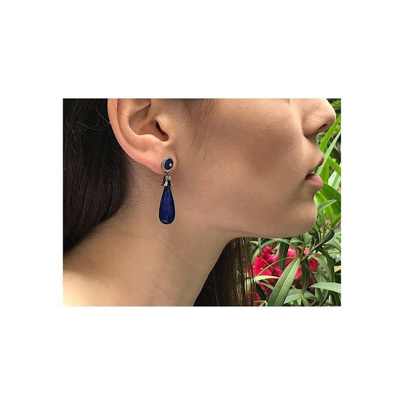 A fine pair of Art Deco dangle earrings in platinum and 18 karat white gold set with four lapis lazuli, two rock crystal discs, two old mine brilliant cut diamonds totaling .02 carat (colour and clarity: G/J, vs/si) and 24 rose cut diamonds. The