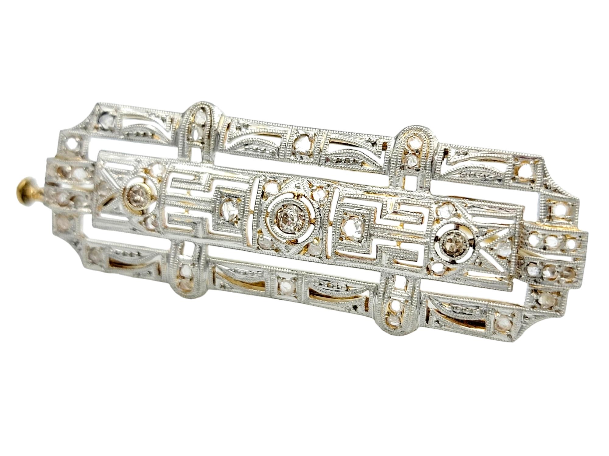 Indulge in the exquisite charm of this vintage art deco brooch, a dazzling display of elegance. Crafted in a captivating assortment of 18 karat yellow gold and platinum, the brooch is adorned with a meticulous arrangement of Old European, rose, and