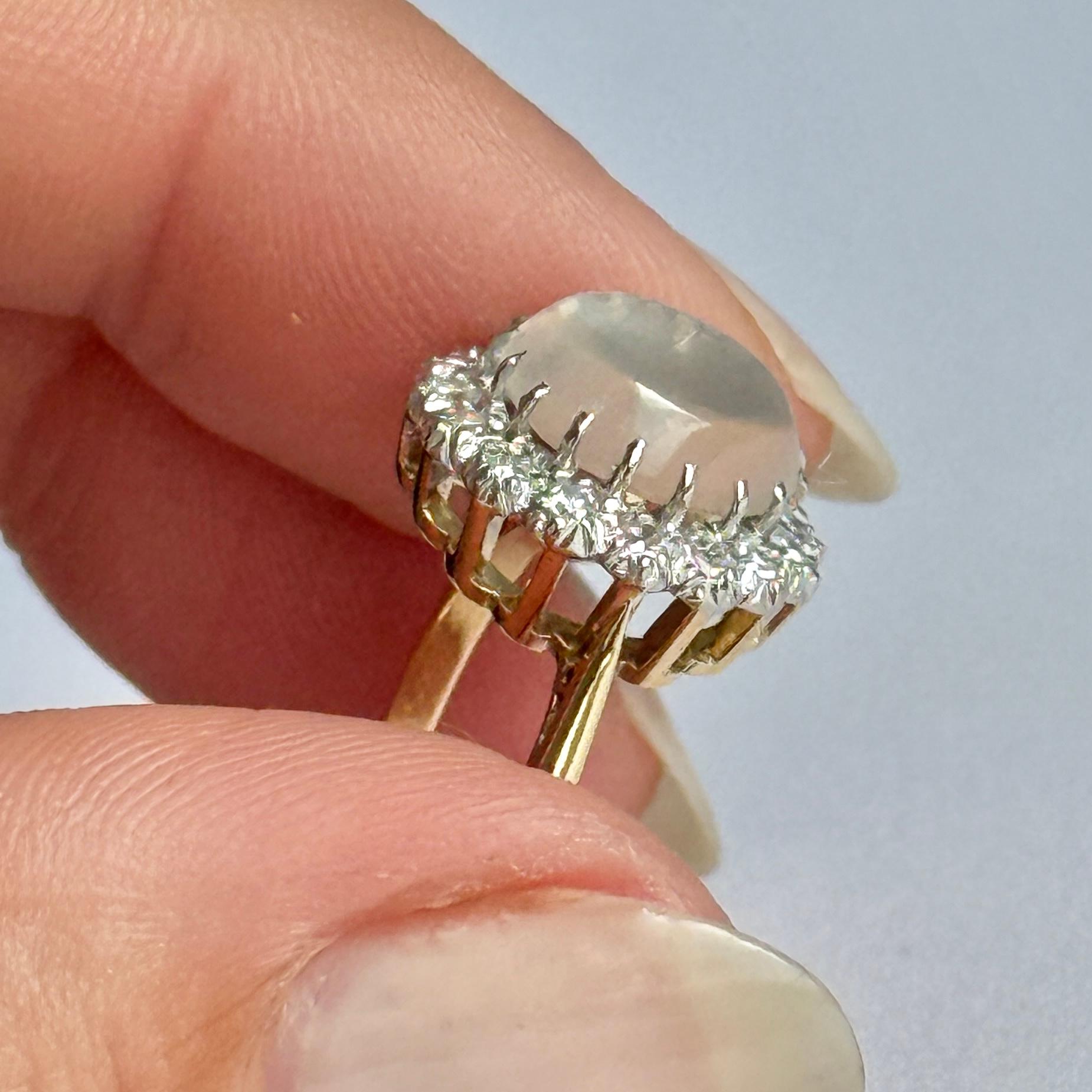 Stunning Art Deco diamond and Moonstone ring. This ring is modelled in 18 carat gold and the stones set in platinum. The diamonds total approx 48pts.

Ring Size: K or 5 1/4 
Height Off Finger: 7mm
Cluster diameter: 14mm

Weight: 4.1g