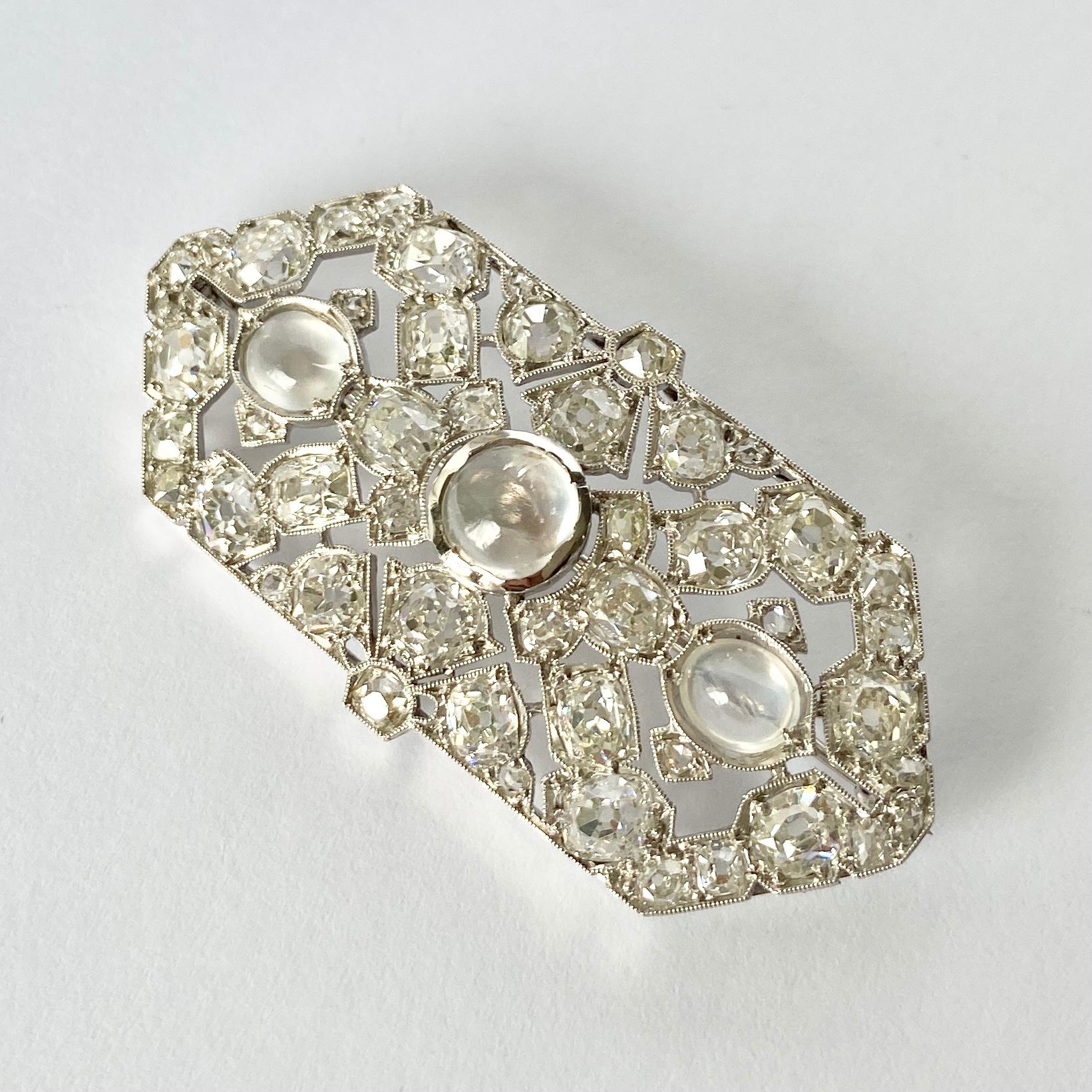 This piece is a sure show stopper! This brooch holds a total of 5.1carats of bright shimmering old mine cut diamonds. Sat at the centre are three moonstones which compliment the diamonds perfectly. Modelled in Platinum.

Brooch Dimensions: