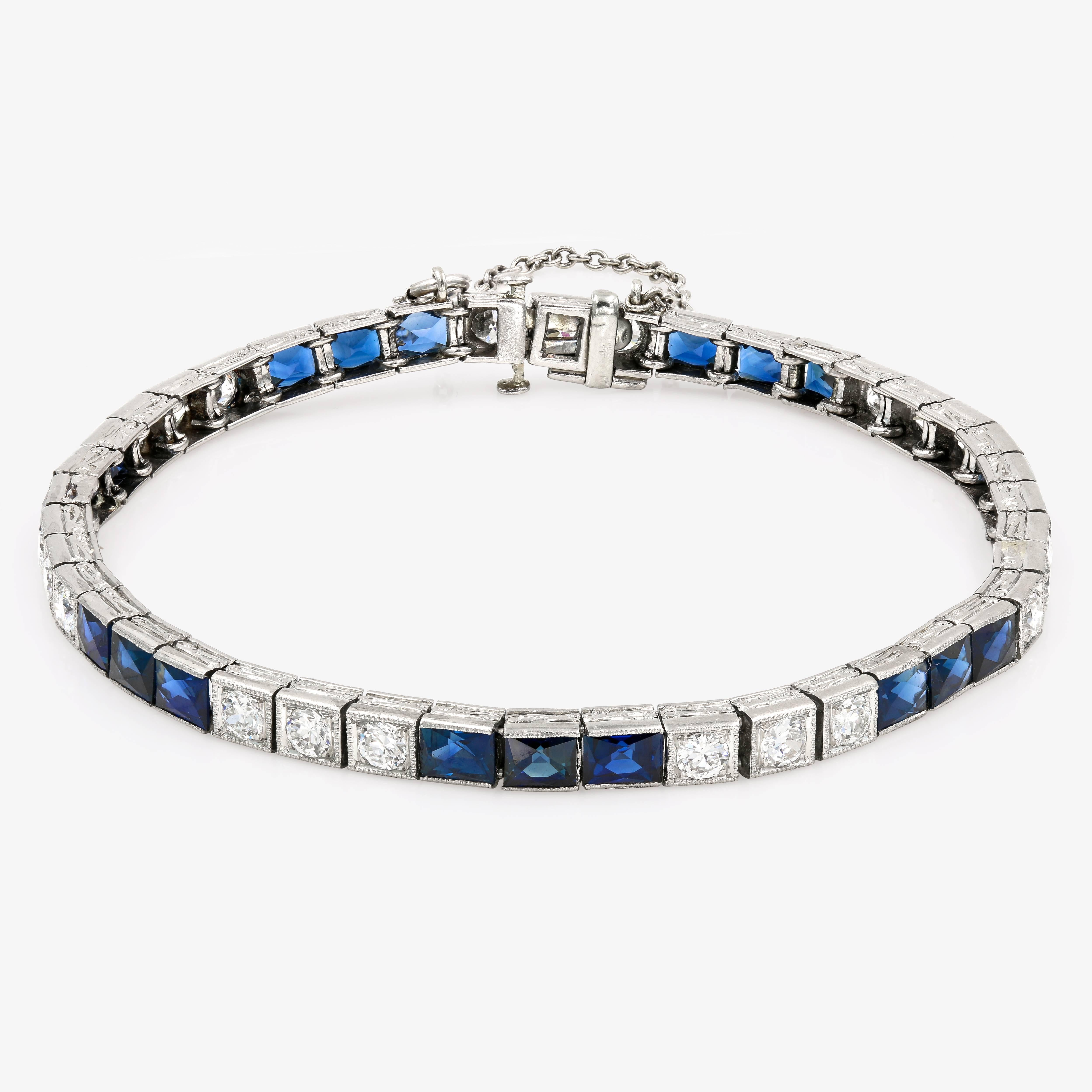 Art Deco tennis bracelet contains 21 round cut diamonds approximately 2.40cts. t.w. and 21 natural blue sapphires approximately 9.50cts. t.w. There is a hidden clasp and a safety chain. We estimate the bracelet to be Circa 1920's and is hand made in