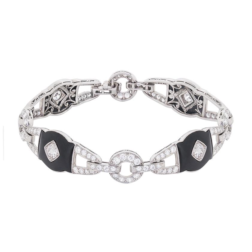 Featuring a collection of old cut diamonds and hand cut onyx pieces, this bracelet is unique and well made. The sparkling diamonds in the centre of each piece of Onyx have a combined weight of 0.40 carat, and the remainder of the diamonds weigh 5.90