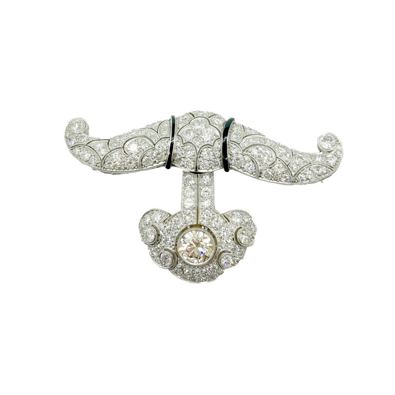 A beautiful Art Deco pendant-brooch in white gold with diamonds (central stone 2.5 cts, J/K, SI, total weight of remaining stones approximately 11 cts) and black onyx.  