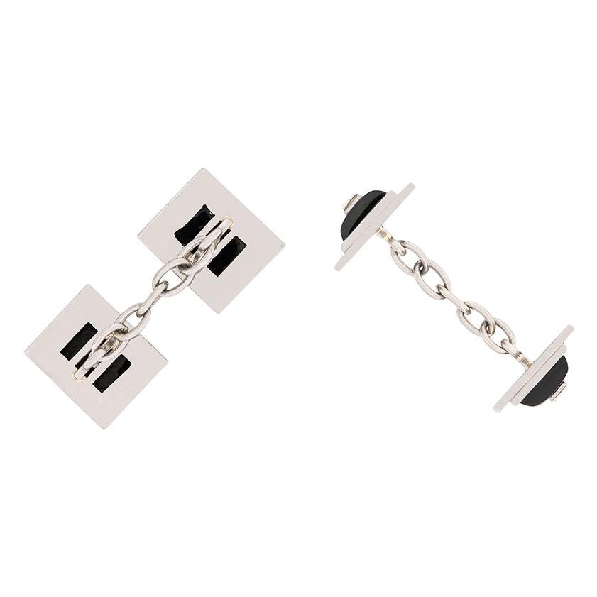 Dating to the 1920s, these cufflinks features baguette cut diamond surrounded by deep black onyx. The diamonds have a combined weight of 0.40 carat and are G in colour, VS in clarity. The stones and onyx are all set within platinum and the art deco