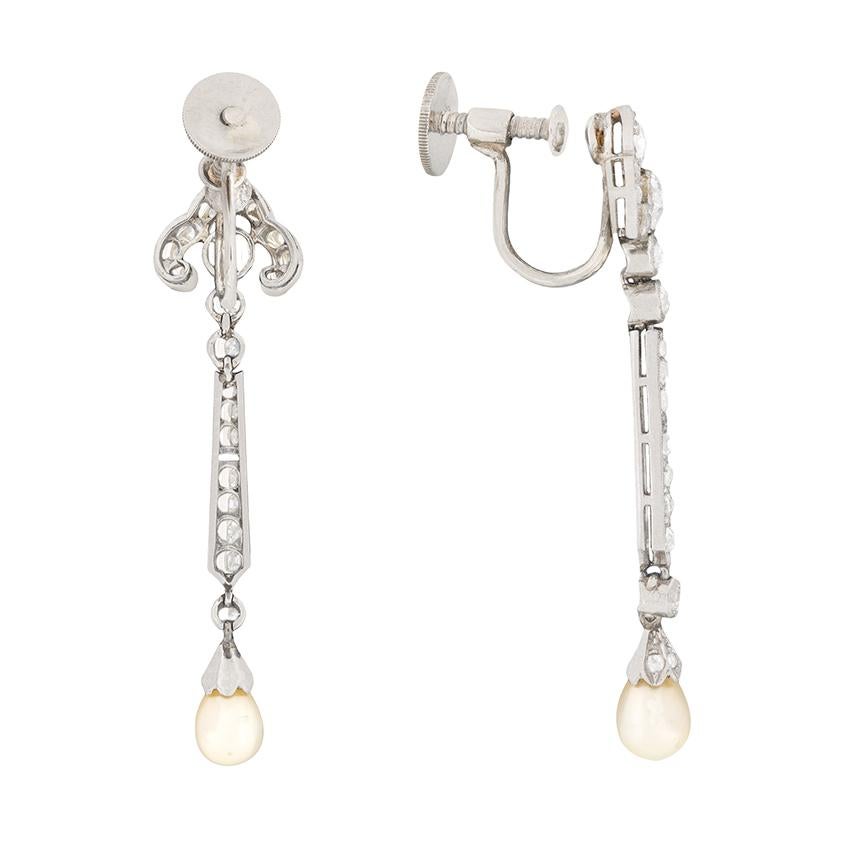 These beautiful earrings date back to the 1920s and have a classic art deco look to their design. The main diamonds weigh a total of 1.00 carat and are wonderfully hand cut. The old cuts are then expertly highlighted by the grain set rose cuts