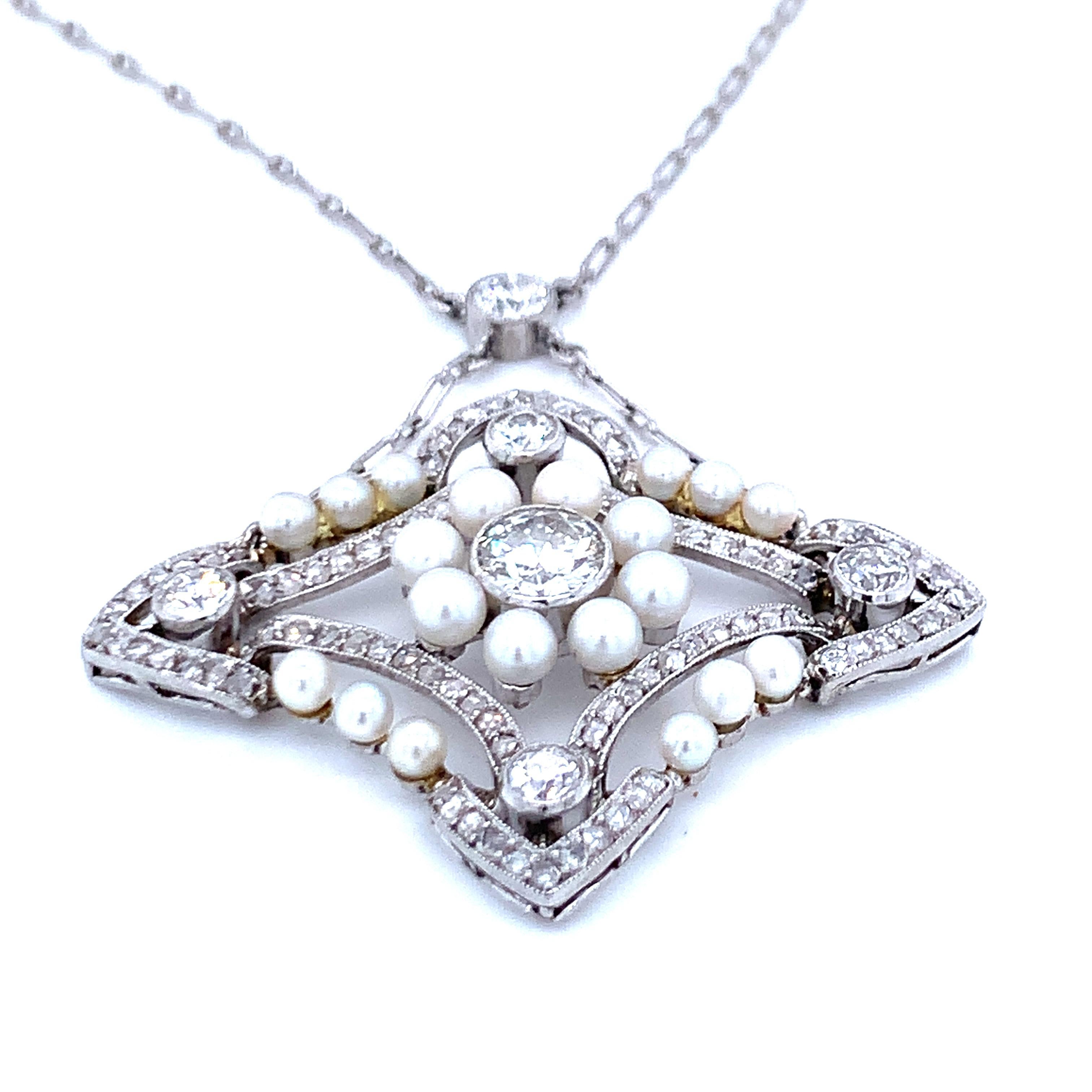 One Art Deco diamond and pearl platinum pendant featuring a modified marquise shaped pendant portion featuring 96 old European and rose cut diamonds totaling 3.25 ct. with H-I-J color and SI-2 clarity with the center diamond weighing 0.70 ct. The