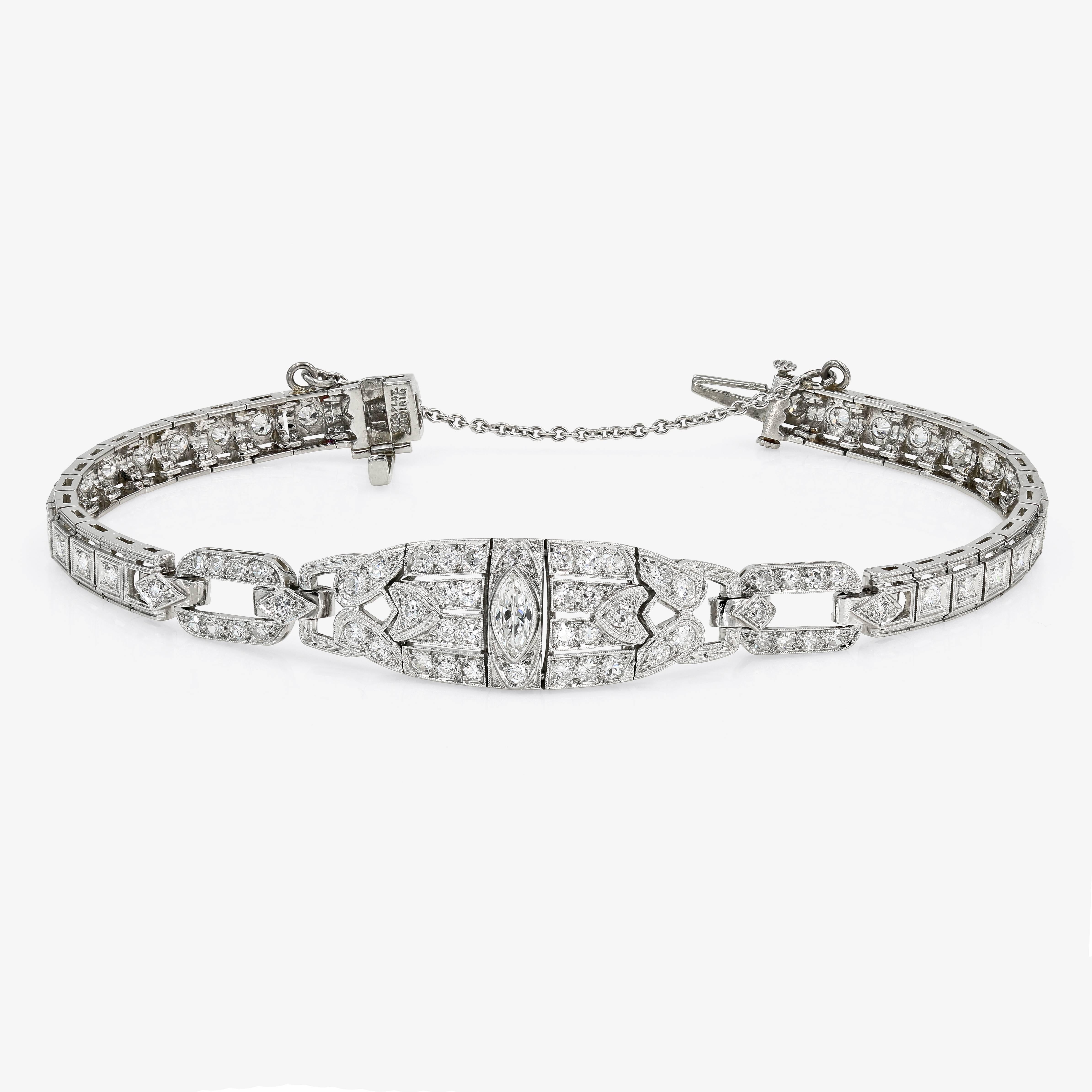 This stunning Art Deco estate bracelet in platinum is set with one marquise cut diamond= .15ct. (F in color and VS2 in clarity), 66 old mine cut round diamonds approx. 1.40cts. t.w. (G-H in color and VS in clarity) and 16 single cut round diamonds=