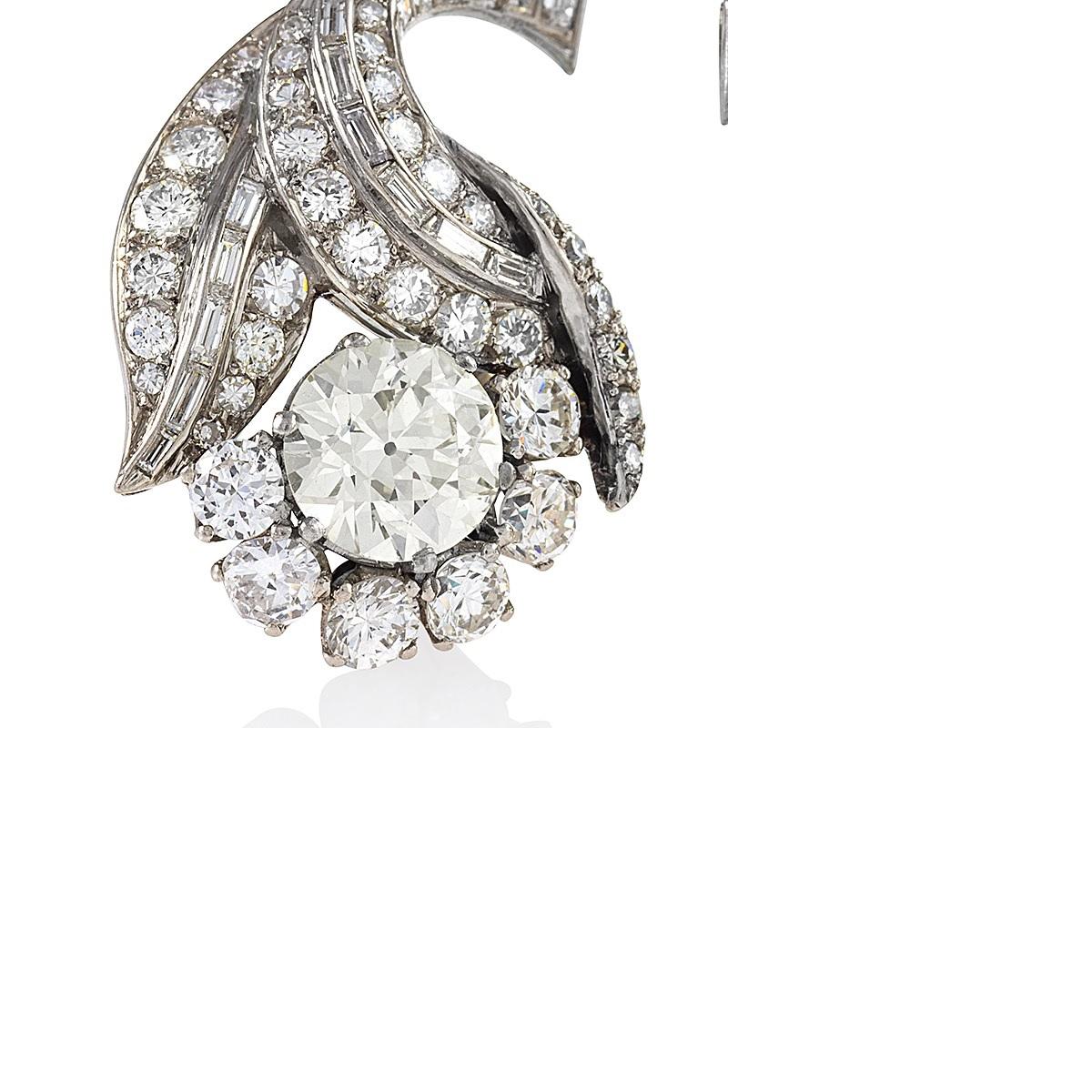 These curvaceous French Late Art Deco platinum flower earrings, with over fourteen carats of diamonds, possess all the glamour of Hollywood's golden age. Set with baguette-cut diamonds, the curving stem branches into three leaves set with round-cut