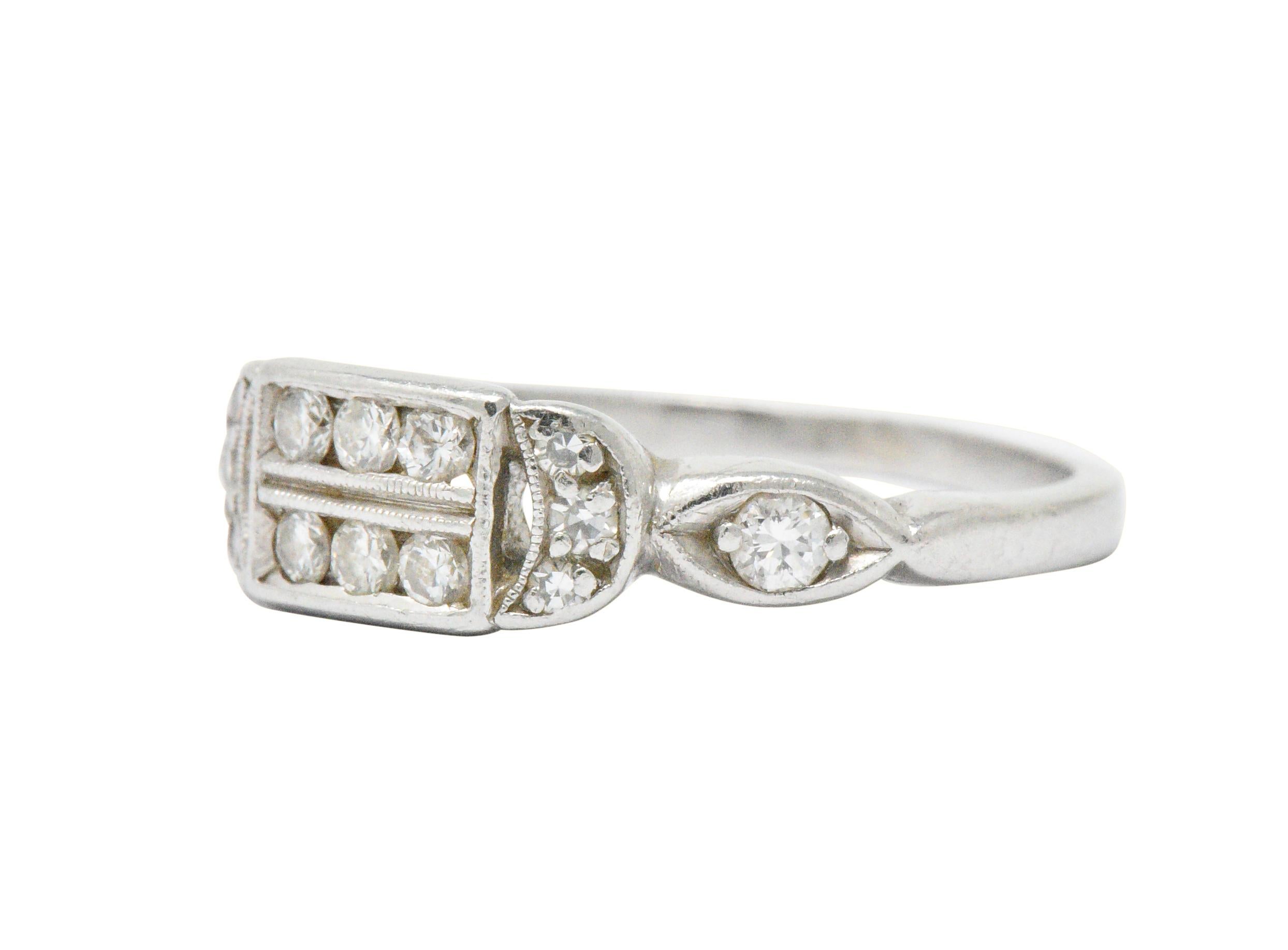 Set to the front with single and full cut diamonds, approximately 0.20 carats total, G/H color and VS to SI clarity

Elegantly designed with straight geometric and curved lines, so perfectly Art Deco

Ring Size: 4 3/4 & Sizable

The top of the ring