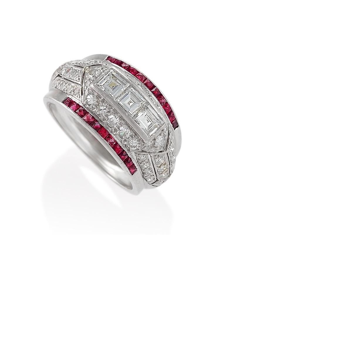 An Art Deco platinum ring with diamonds and rubies. The ring has 50 round diamonds with an approximate total weight of 1.20 carats, 3 square-cut diamonds with an approximate total weight of .90 carat, and 22 French-cut rubies with an approximate