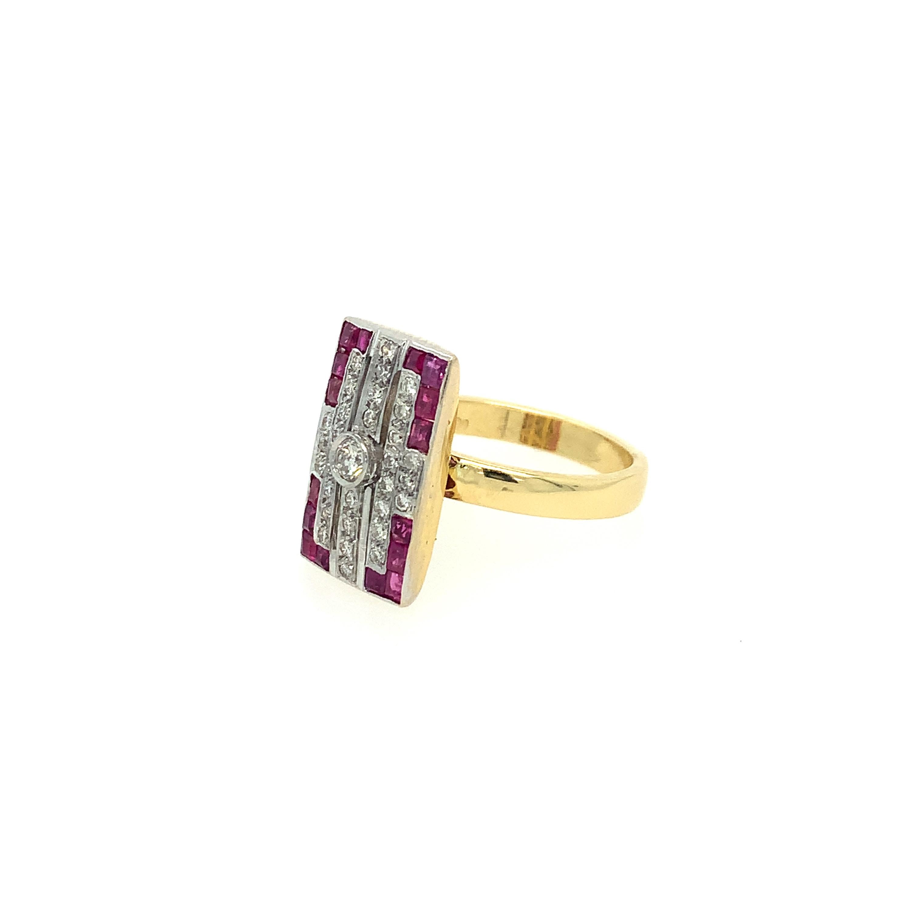 In the style of Art Deco, this 18K two tone ring is a showstopper. Featuring a vertically arranged combination of rubies and diamonds, this rare piece is framed by a beautiful and intricate geometric border of colorful gems. Centered by a round cut