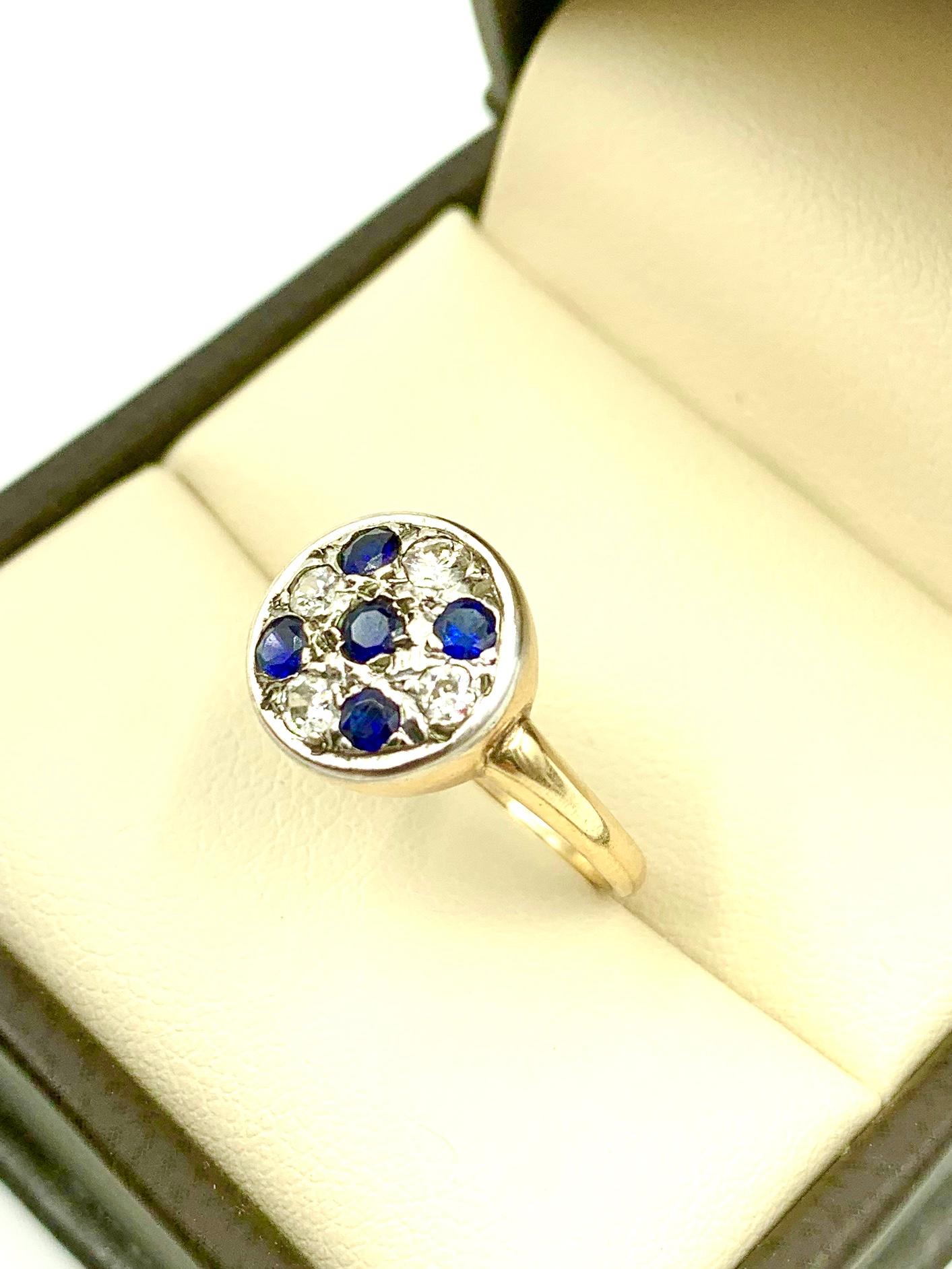 Beautiful Art Deco period diamond and sapphire Circle ring composed of four diamonds and five blue sapphires set in platinum and 14K yellow gold. 
Fine quality, lovely design with the sapphires forming a cross within the circle. The circle is widely