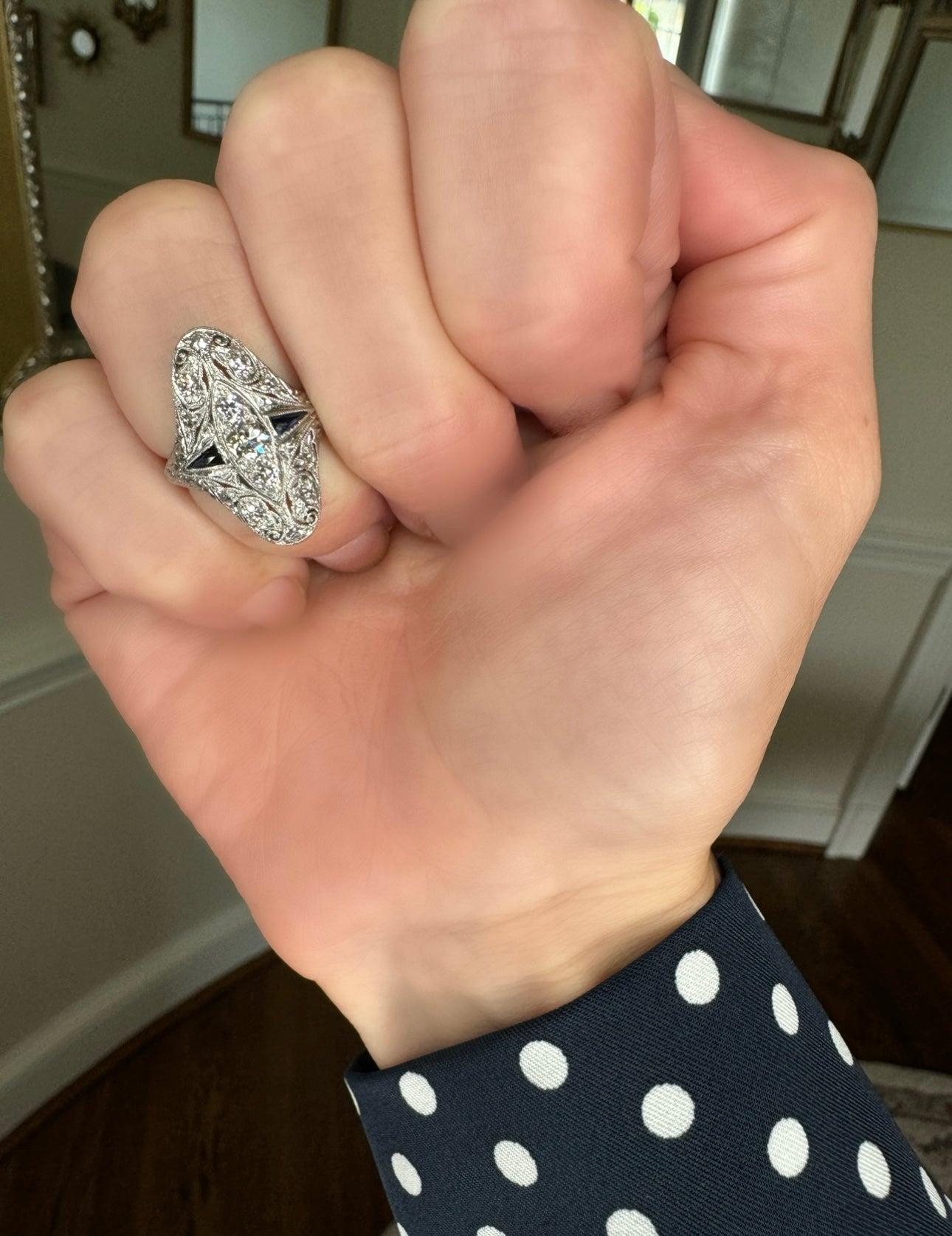 Expertly crafted from 14K gold, this Art Deco diamond and sapphire ring showcases intricate filigree details. Its vintage design exudes a timeless elegance, making it the ideal choice for an engagement ring. Channel your inner art deco with this