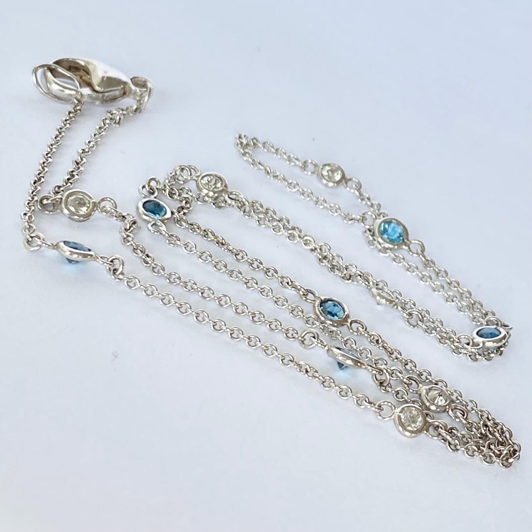 An elegant Art Deco chain necklace set with diamonds and sapphires and modelled in 18carat white gold. Each diamond is sat in a delicate circle of white gold. The diamonds totals 30pts and are bright and add the perfect sparkle to this chain the