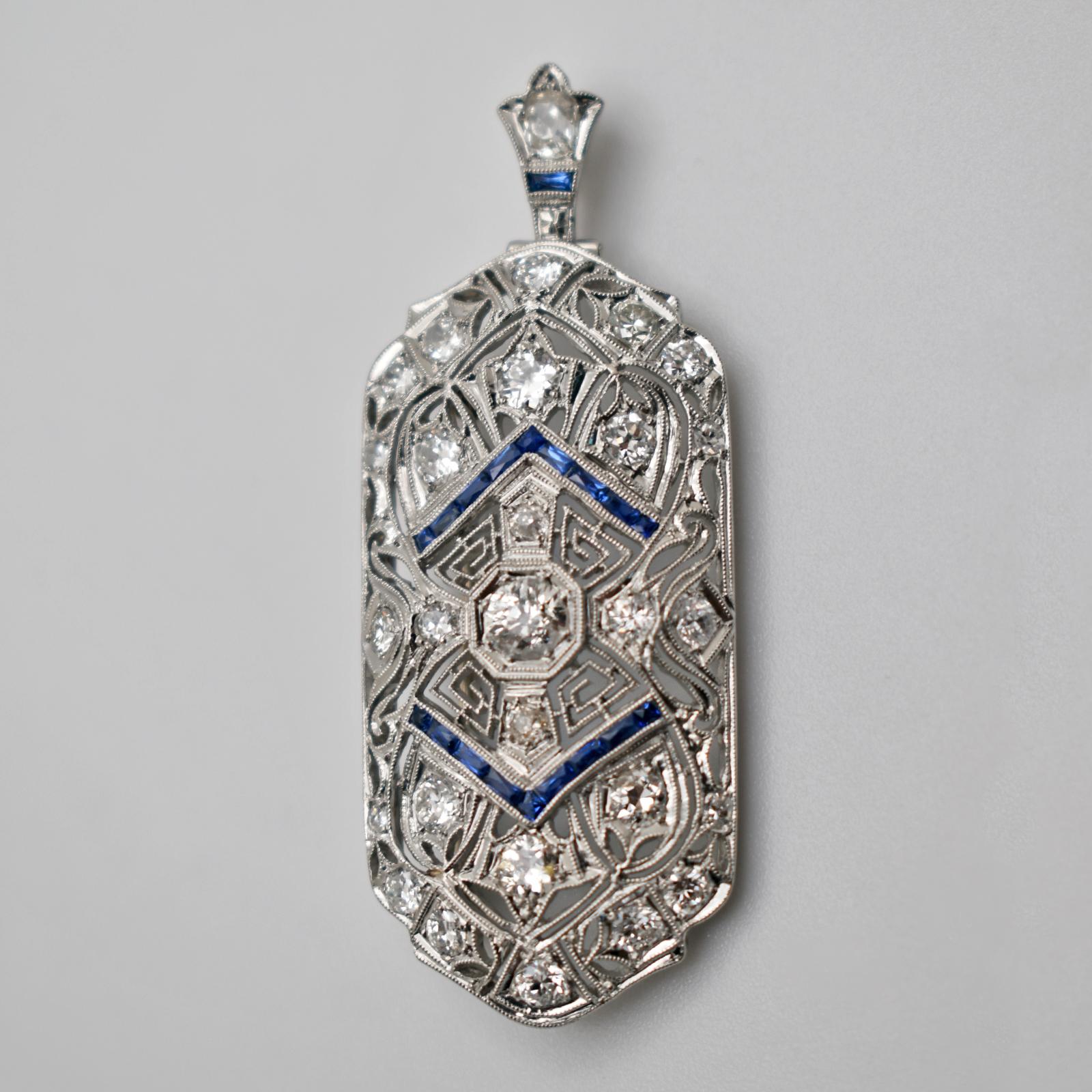 Art Deco style Diamond and blue Sapphire 18k white gold convertible brooch pendant with incredible metal work, detailed design, and delicate filigree and granulation. This brooch pendant is in great antique condition, ready to be worn and