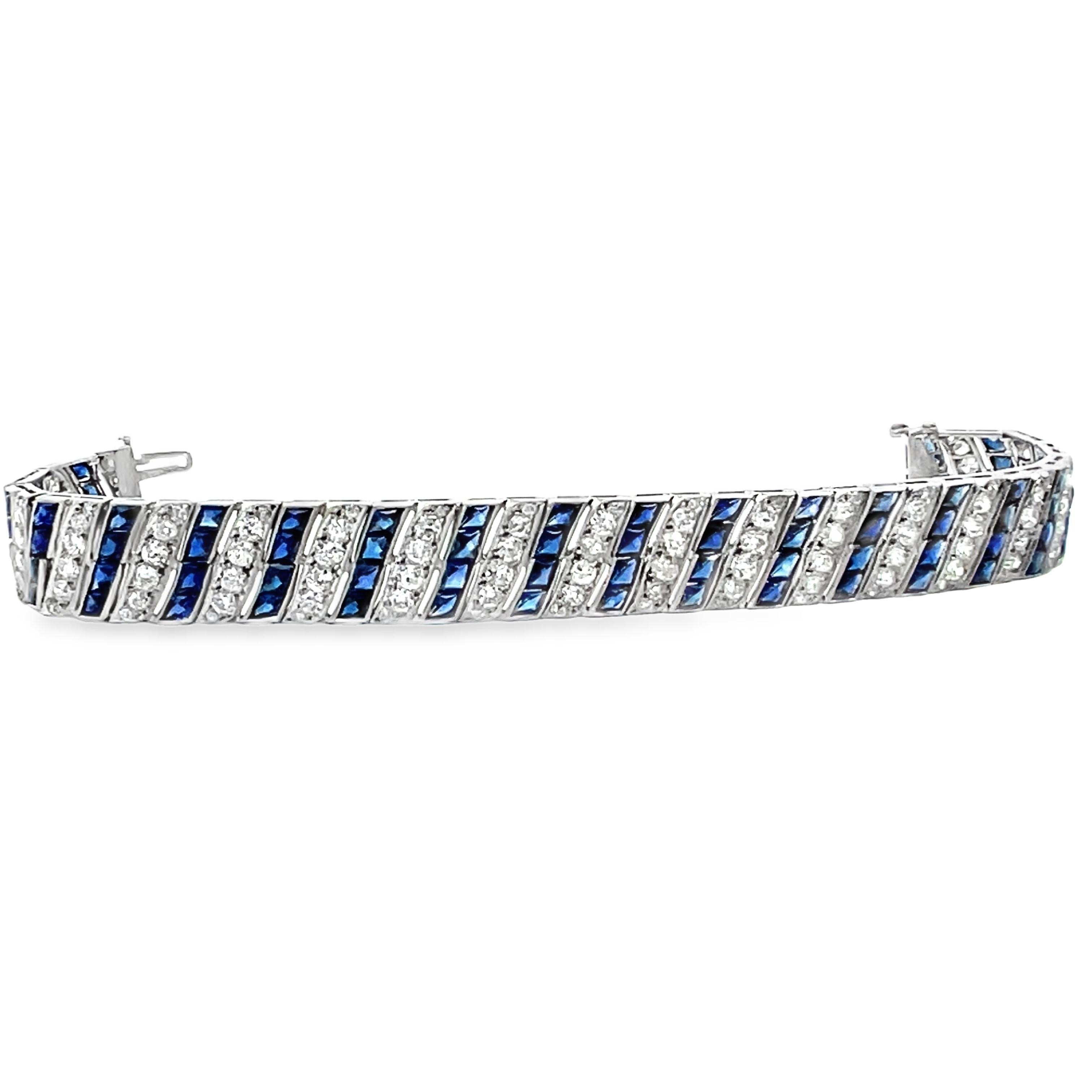 This exquisite Art Deco platinum bracelet showcases a mesmerizing design featuring 6 carats of old-cut white diamonds and intricately faceted carré-cut synthetic blue sapphires, all invisibly set for a seamless, luxurious look. The delicate filigree