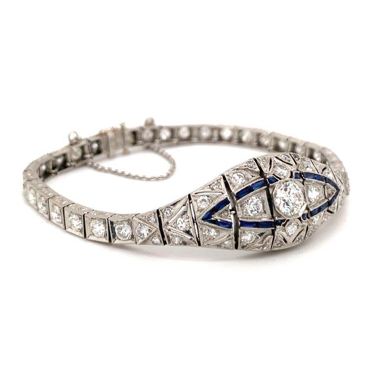 One Art Deco diamond and sapphire platinum bracelet centering 1 old European cut diamond weighing 0.95 ct. and featuring 64 old European cut and single cut diamonds totaling 5.50 ct. Further enhanced by 21 French cut blue sapphires totaling 1 ct.