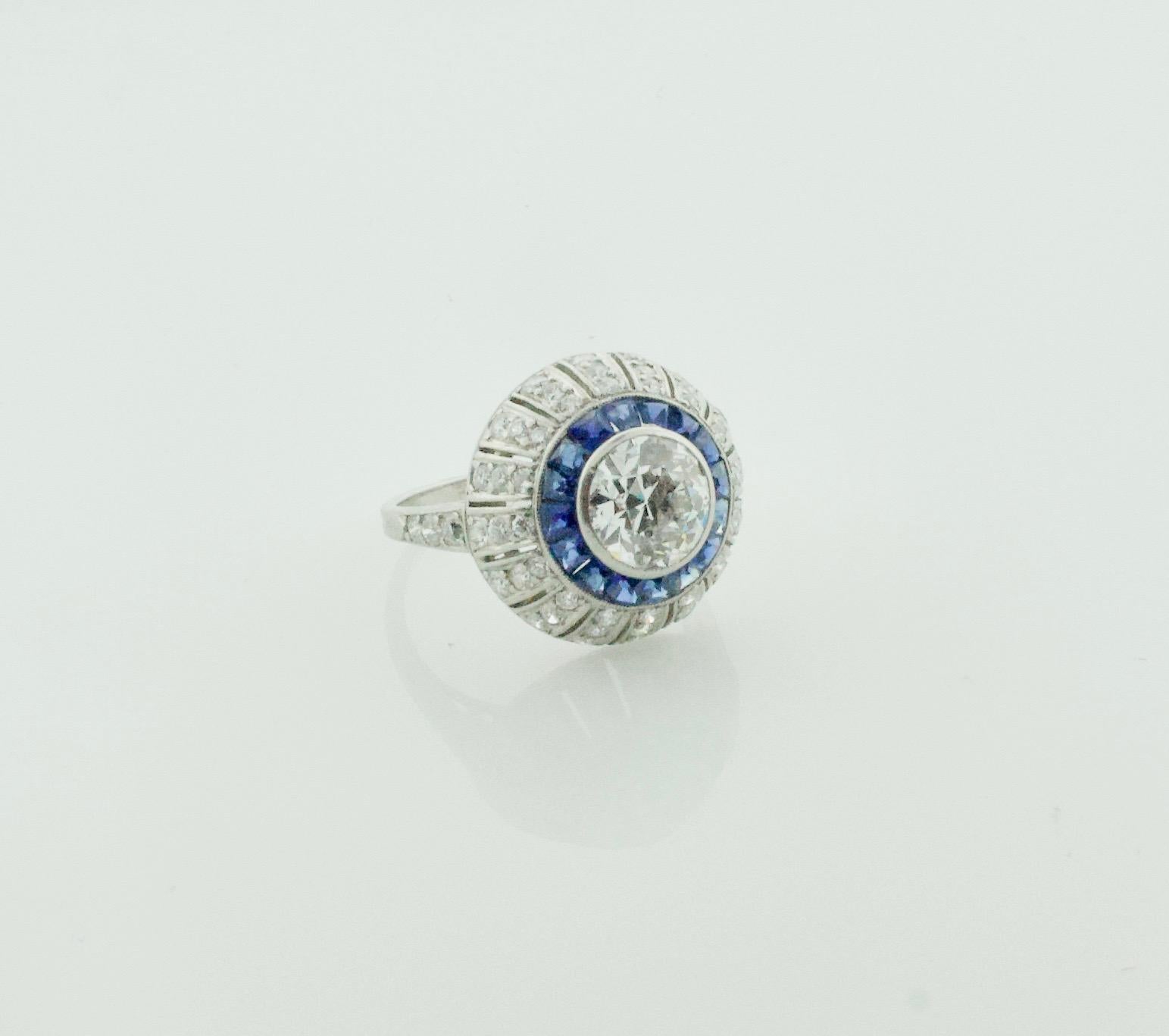 Art Deco Diamond and Sapphire Ring in Platinum Circa 1920's
A Exceptional Vintage Ring
One Old European Cut Diamond Weighing 1.25 Carats Approximately [J VS2]
Fifty Four Round Cut Diamonds Weighing 1.70 Carats Approximately 
Fourteen French  Cut