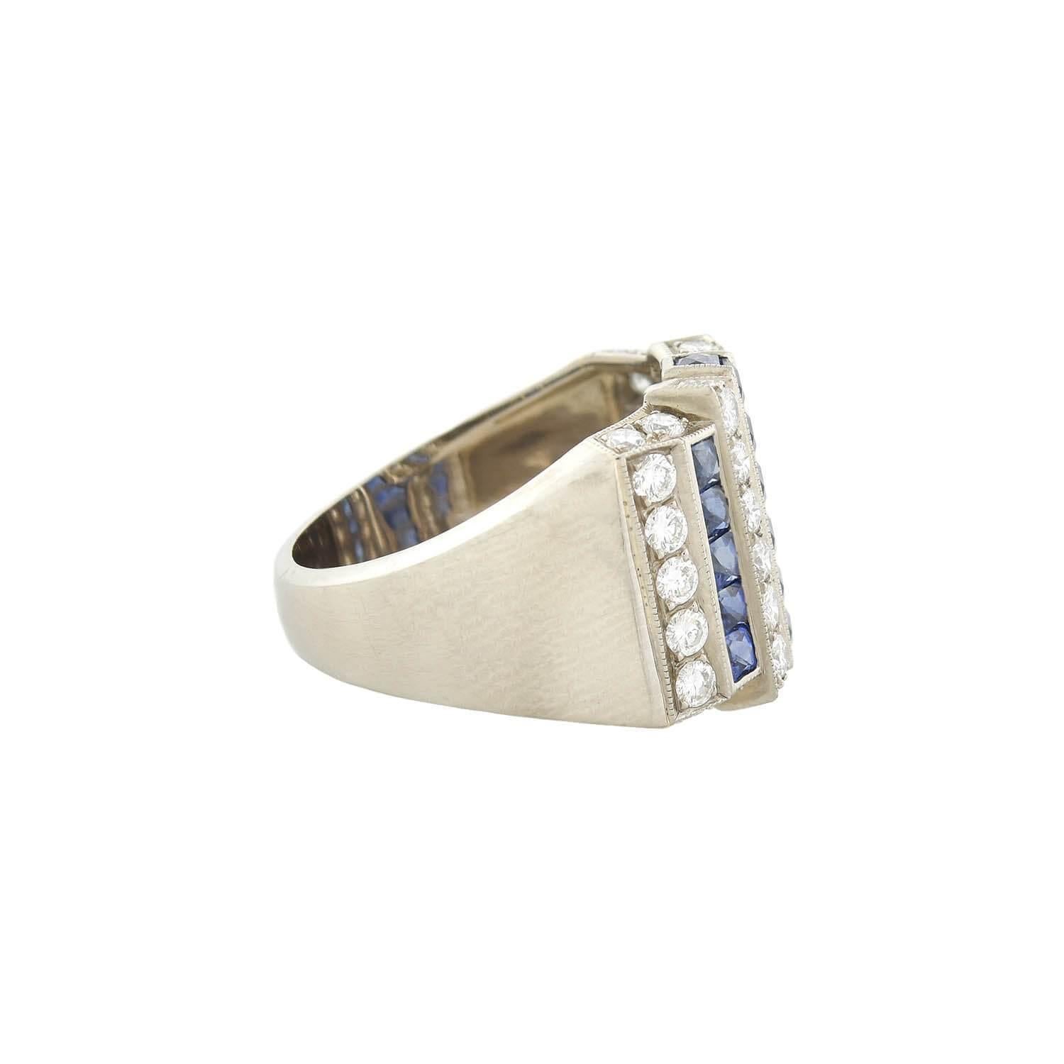 A bold diamond and sapphire ring from the Art Deco (ca1930s) era! Crafted in 18kt white gold, this fabulous piece features a bold gemstone design across its front surface. Three rows of glittering French Cut sapphires alternate with four rows of