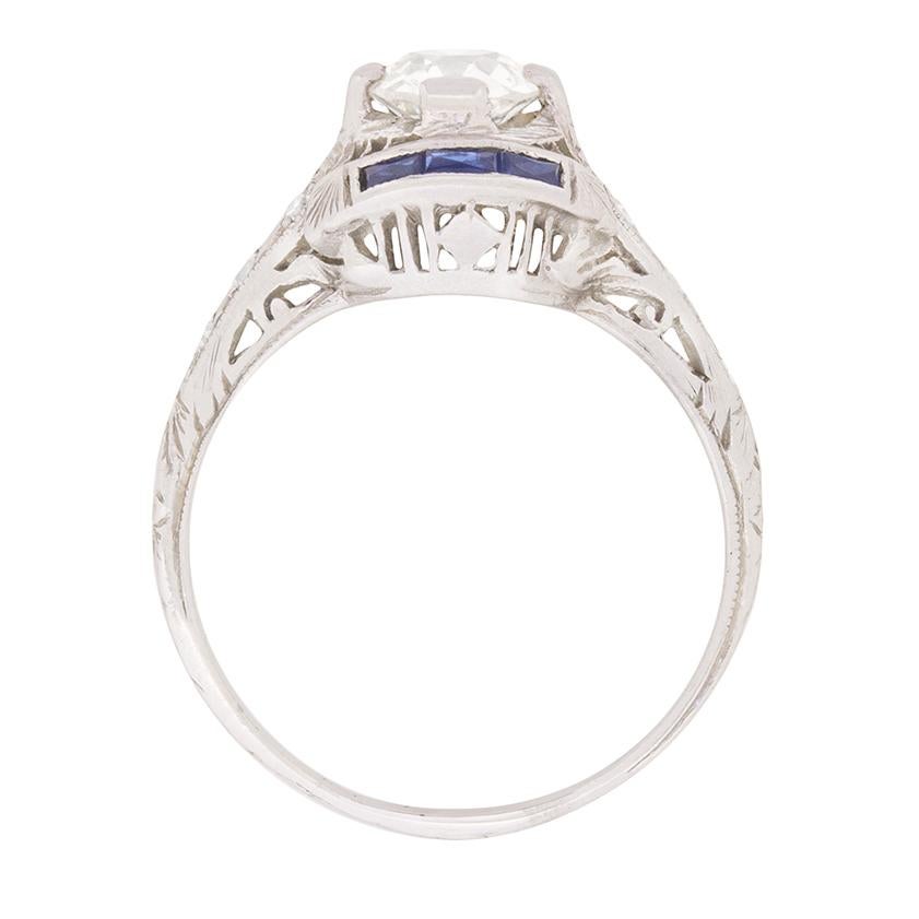 A stunning Diamond solitaire ring supported by lovely deep blue sapphires, this ring is completely art deco. The centre stone is an old cut diamond, weighing 0.64 carats and has a grade colour of H and clarity SI1. EDR have certified the stone. The