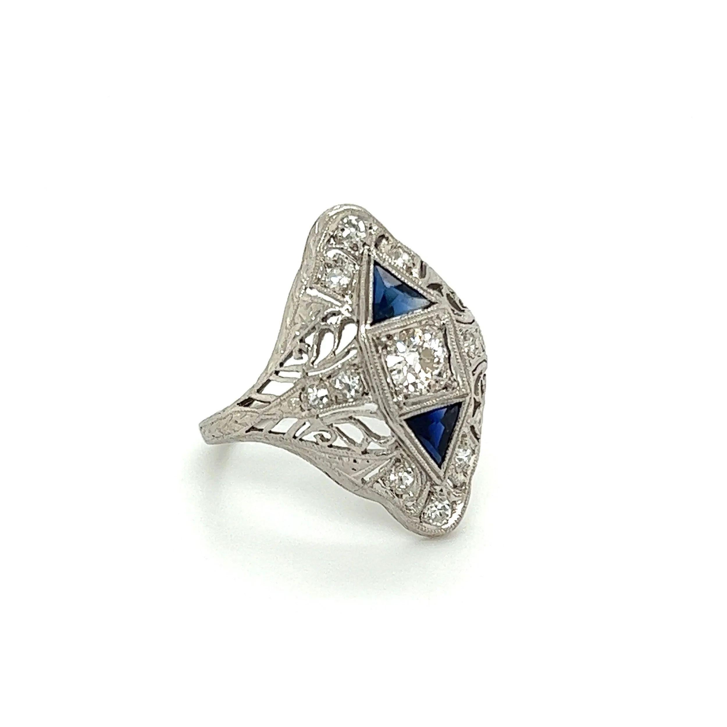 Simply Beautiful! Elegant and finely detailed Art Deco Platinum Diamond and Sapphire Navette Vintage Cocktail Ring. Centering a securely nestled Hand set OEC Diamond, weighing approx. 0.25 Carat. Surrounded by Diamonds, approx. 0.18tcw, accented by