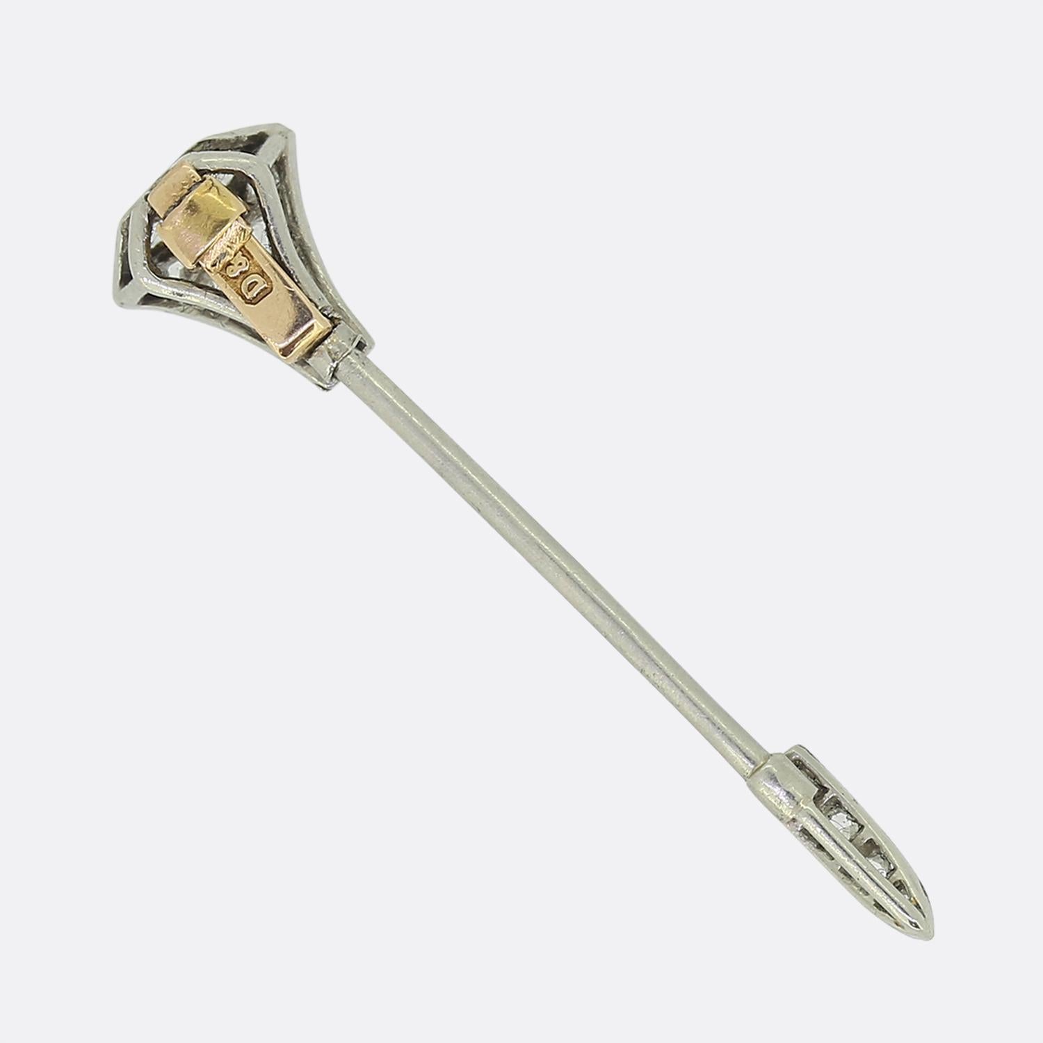 Here we have a classic jabot pin crafted during the early stages of the 20th century. This platinum piece takes on the form of an arrow with rose cut diamonds set at the flights and tip; all of which are contained within a fine milgrain detailing.