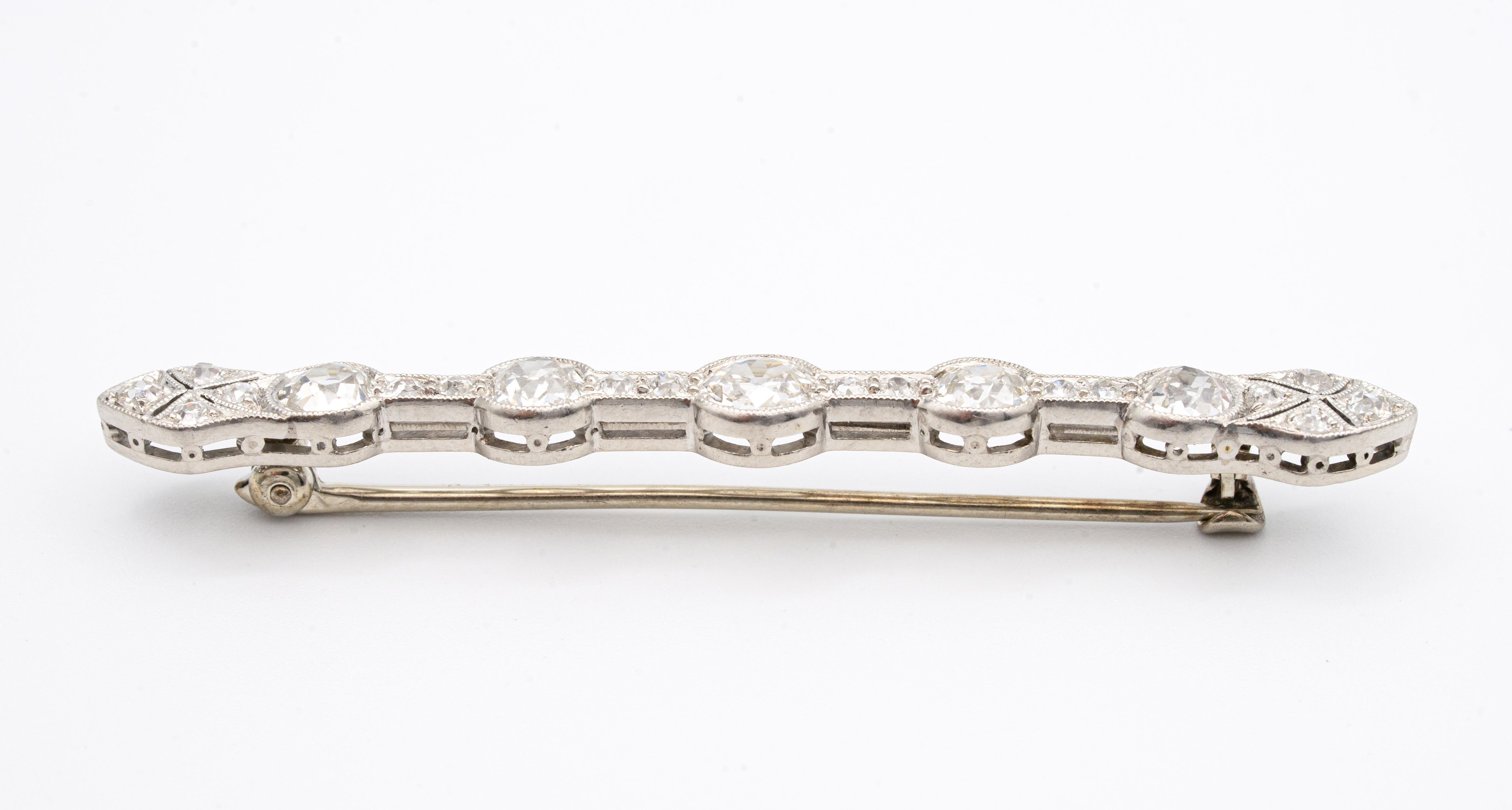 Art Deco barpin finely crafted in platinum with 5 large old-mine cut diamonds  graced as the center of this elegant pin accented by an additional 16 old European-cut diamonds and milgrain filigree finish. The center old mine diamond weighs