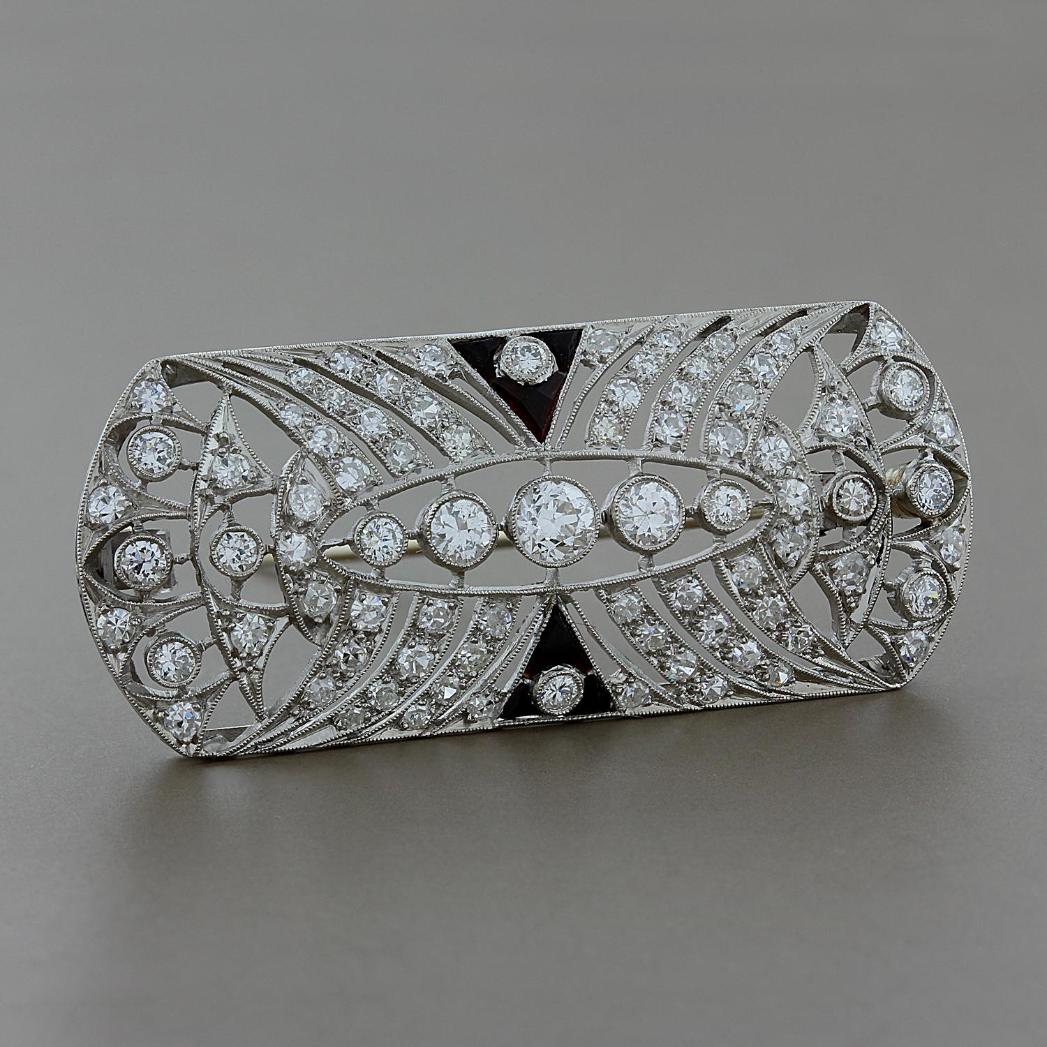 This Art Deco, early 20th century, brooch features antique cut diamonds weighing a total of 1.60 carats, accented by calibré-cut black onyx, set in platinum.

Brooch Length: 1 3/4 inches
Brooch Width: ¾ inch

