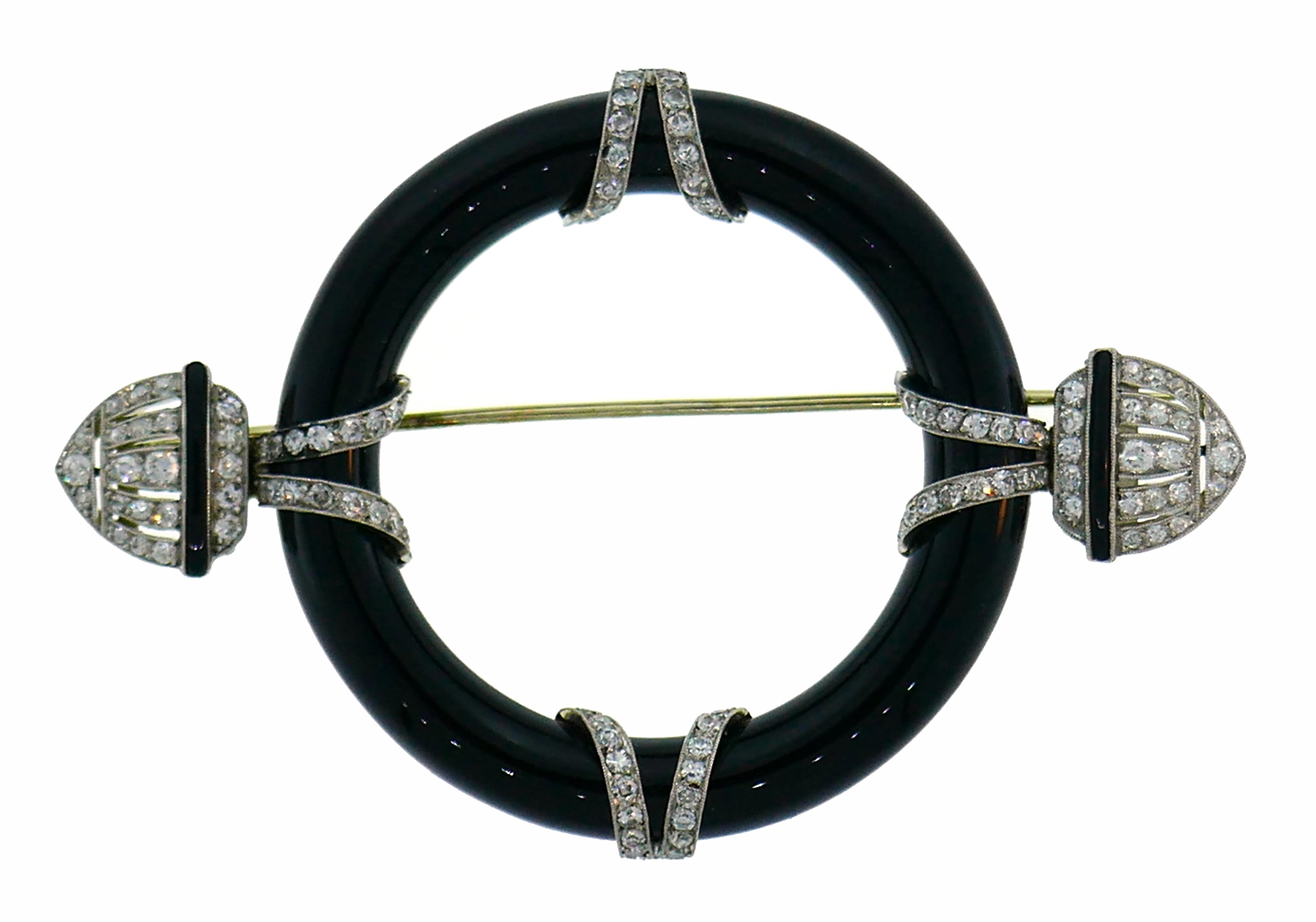 Classy and elegant Art Deco brooch created in the 1910s. 
The pin is made of platinum, black onyx and accented with Old European and single cut diamonds (H-J color VS clarity, total weight approximately 2.20 carats). The back of the brooch is made
