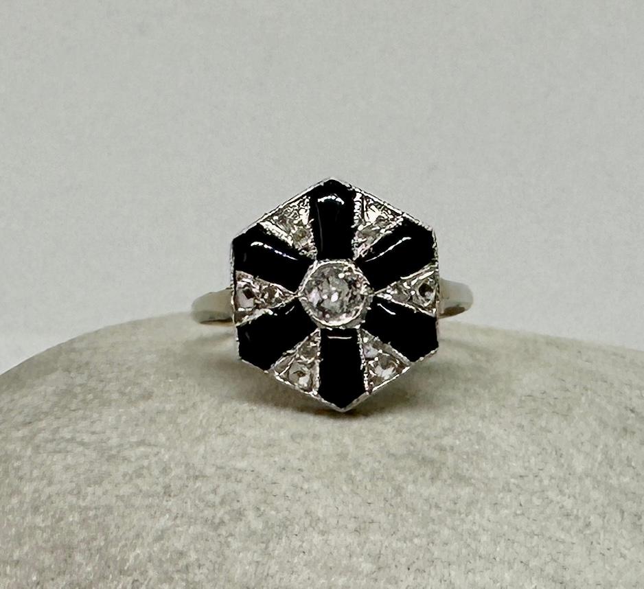 This is a magnificent antique Old Mine and Rose Cut Diamond and Black Onyx Platinum Art Deco Ring of great beauty.   The classic black and white design exudes the beauty of the Art Deco period.  In the center is a gorgeous Old Mine Cut Diamond. 