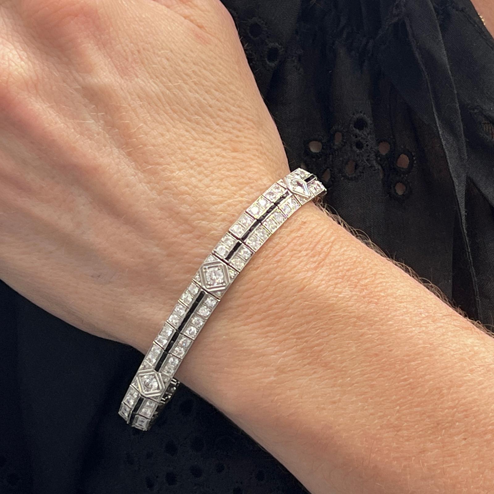 Stunning Late Deco diamond and sapphire bracelet handcrafted in platinum. The bracelet features 6 round brilliant cut center diamonds weighing approximately 1.50 CTW and another 120 round brilliant diamonds weighing approximately 5.00 CTW. The