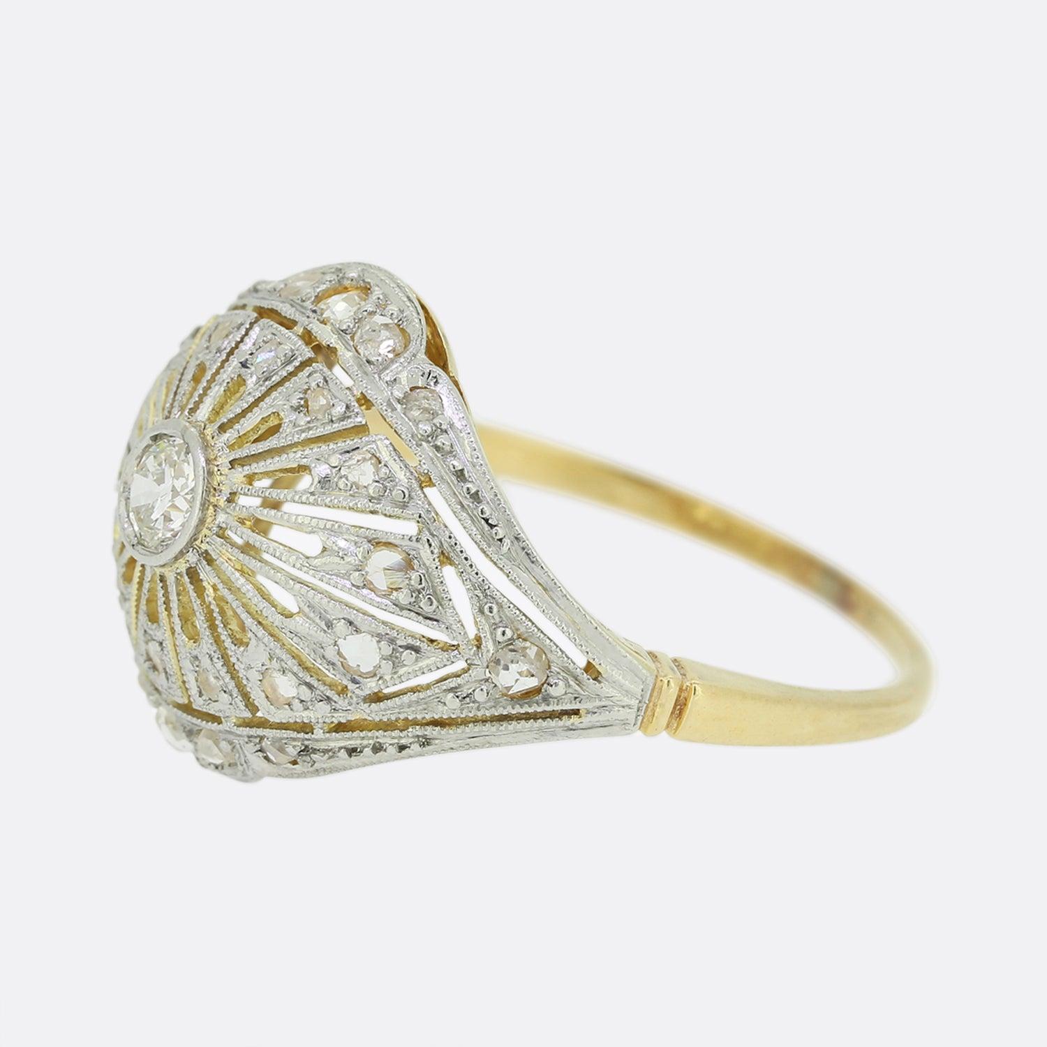 This is a wonderful diamond bombe ring from the Art Deco era. The ring features a central old cut diamond which is surrounded by a halo of rose cut diamonds in a bombe style setting crafted in platinum with an 18ct yellow gold band. 

Condition: