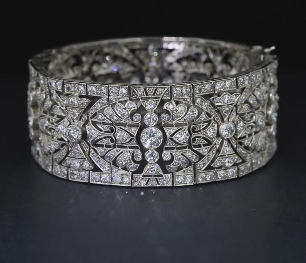 Open metalwork and distinct geometric lines define this bracelet from the Deco Era. Crafted in platinum with millegrain finishes, the bracelet is set with approximately 471 round diamonds weighing approximately 20 carats in total. The diamonds have