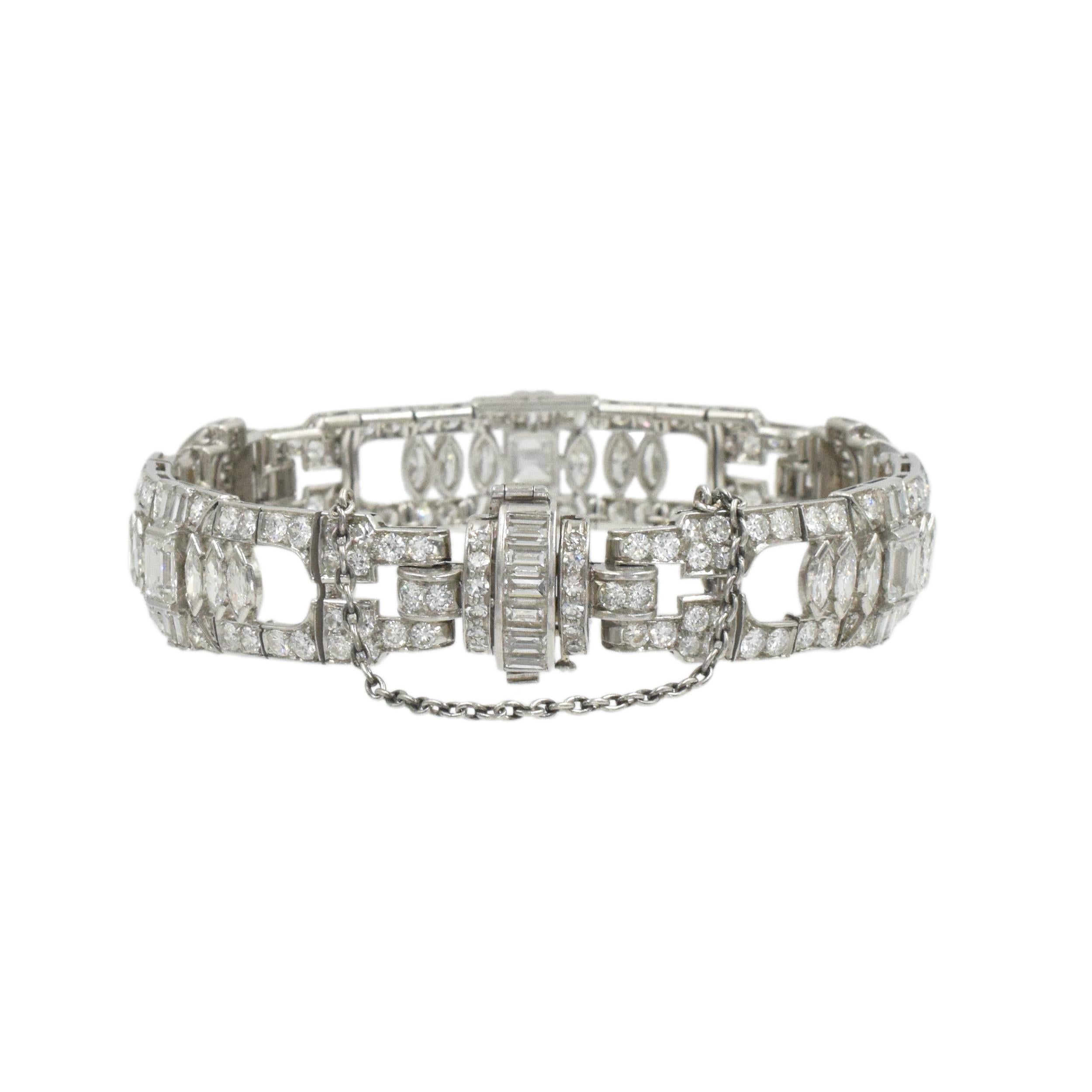 Art Deco Diamond Bracelet In Platinum. The bracelet is adorned with three rectangular step cut, 18 marquise, 30 baguette and numerous transitional and single cut diamonds weighing
total of approximately 10.00 carats, Color: G color Clarity: VS
 The