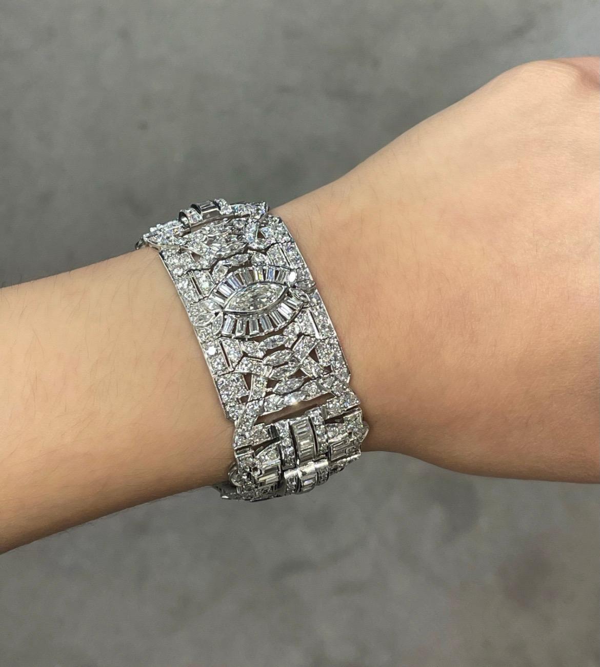 Art Deco Diamond Bracelet 

A wide art deco bracelet set with marquise, round, and baguette cut diamonds. 

Approximate Combined Diamond Weight: 27.06 carats
Approximate Length: 7.5 inches
Approximate Width: 1 inch
Metal Type: Platinum 