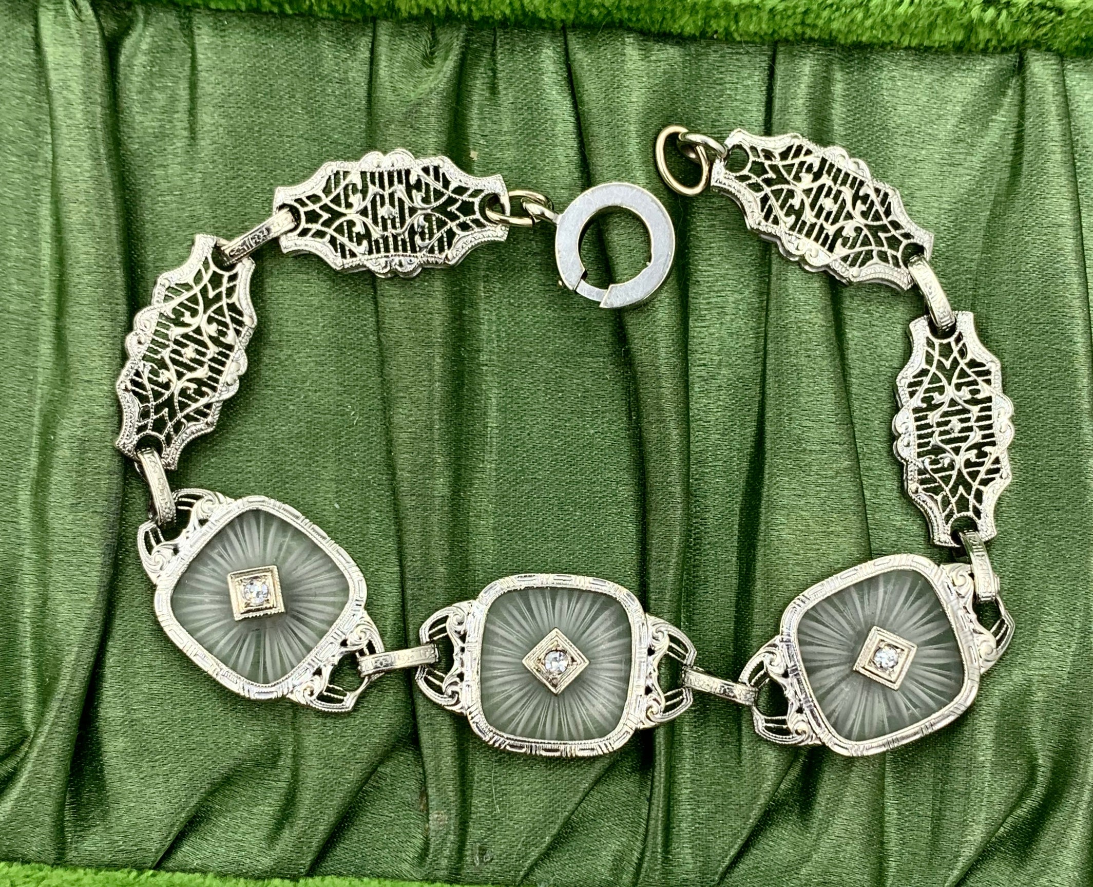 This is a radiant Diamond Frosted Rock Quartz Crystal 14 Karat White Gold Bracelet.  The classic antique Art Deco bracelet of great beauty is set with three square carved Rock Crystal plaques (also known as camphor glass) with a sunburst motif