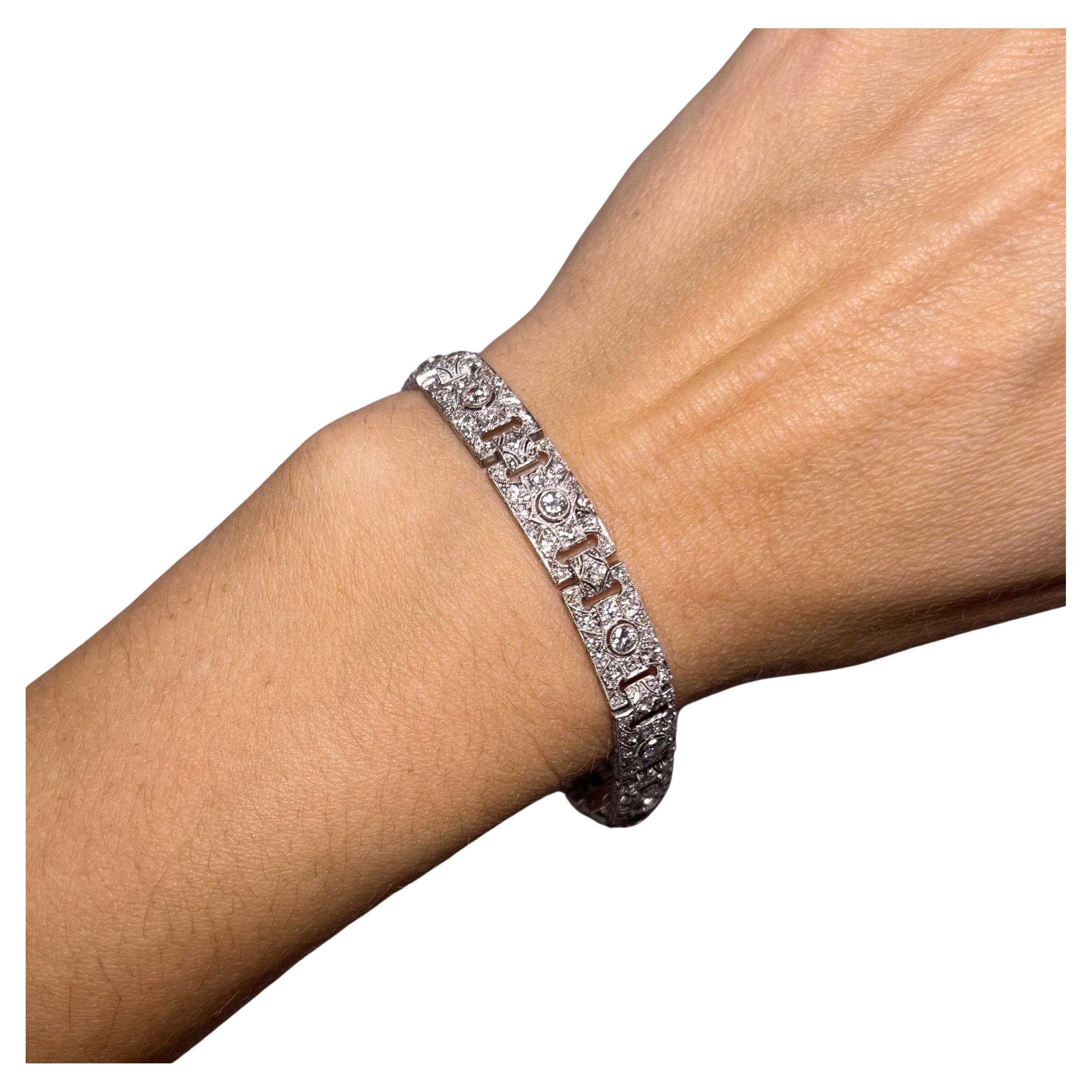 This stunning Art Deco bracelet in fine platinum is adorned with 11 old-cut diamonds totaling 1.32 carats, I-J colour with vs-si clarity, and 164 8/8-cut diamonds totaling 3.28 carats, I-J color and si-1 clarity.

Each diamond sparkles like dew on