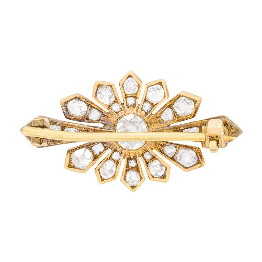 An elegant brooch, ideal for special occasions or everyday wear. The centre diamond, which is rub over set, weighs 0.40 carat. Surrounding within the star-type design is another 0.50 carat's worth of old cut diamonds. They match perfectly in