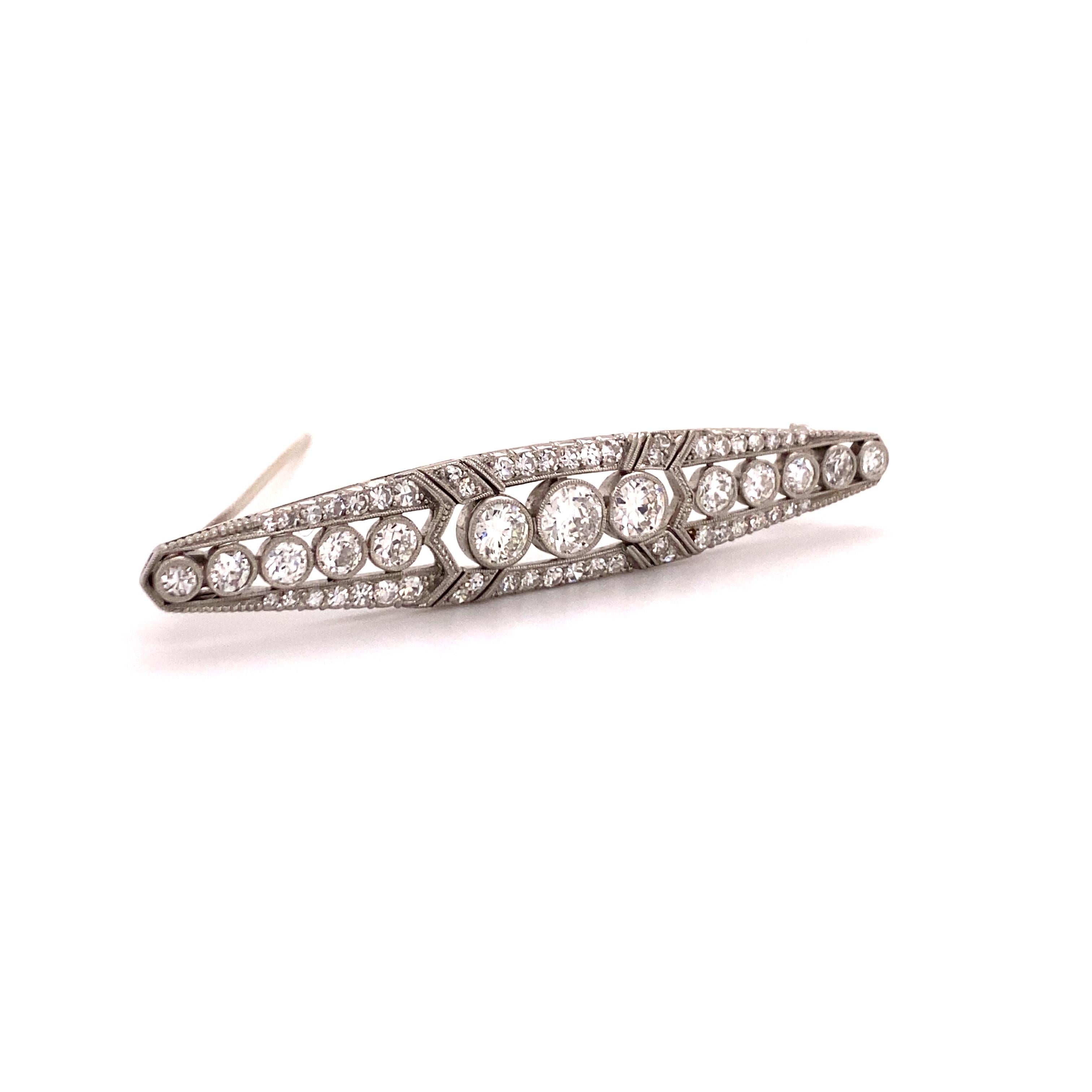 This beautifully handcrafted brooch in platinum 950 features 3 Old European cut diamonds of G/H colour and si1 clarity, total weight approximately 1.62 carats. They are framed by 10 Old European cut diamonds (slightly graduated towards the tips of