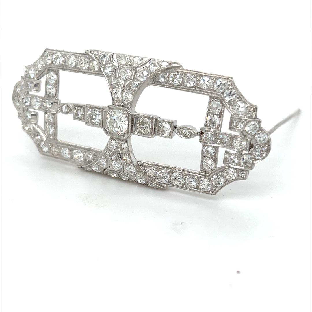 Beautiful platinum art deco diamond brooch with 5.50 carats of old European cut diamonds. There is an estimated 5.50 carats total weight in diamonds, G-I color VS-SI clarity. The pin measures 2 1/2 inches in length and 1 inch tall. The brooch is in