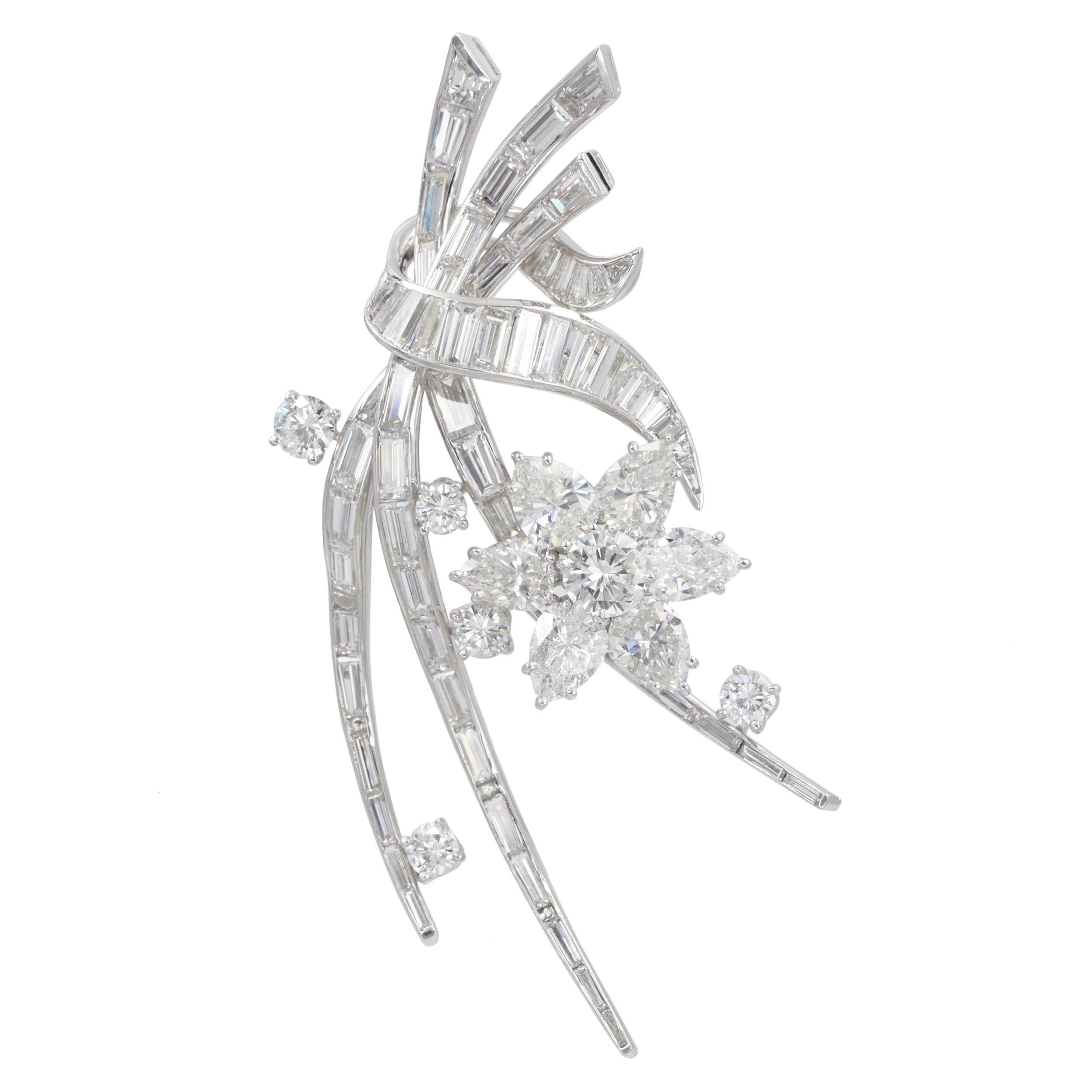 Art Deco  Diamond Floral Brooch In Platinum. 
Center of the flower set with round brilliant cut diamond weighing approximately 0.70ct, petals set with 6 pear-shaped diamonds ap. 3.40ct. Accented with 5 round diamonds ap. 0.90ct; and 64 tapered and