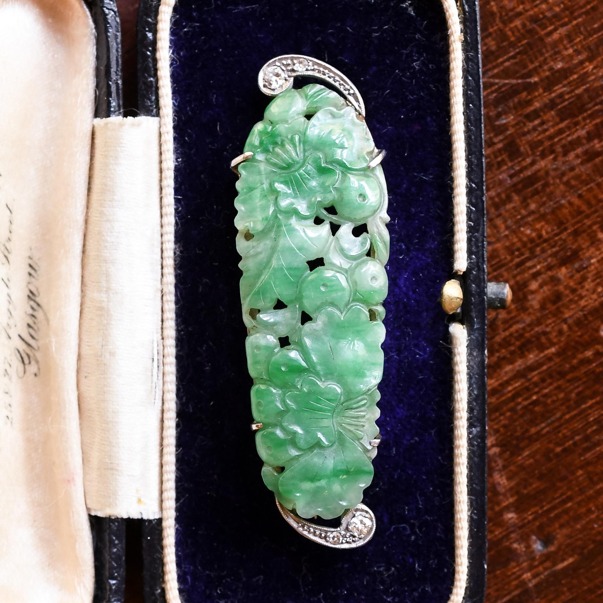 An exceptional carved jade brooch dating from the Art Deco period, circa 1920, although the jade itself is older, Chinese origin, likely carved in mid 19th century. The craftsmanship is exceptional, characterised by opium poppies and foliage. It's