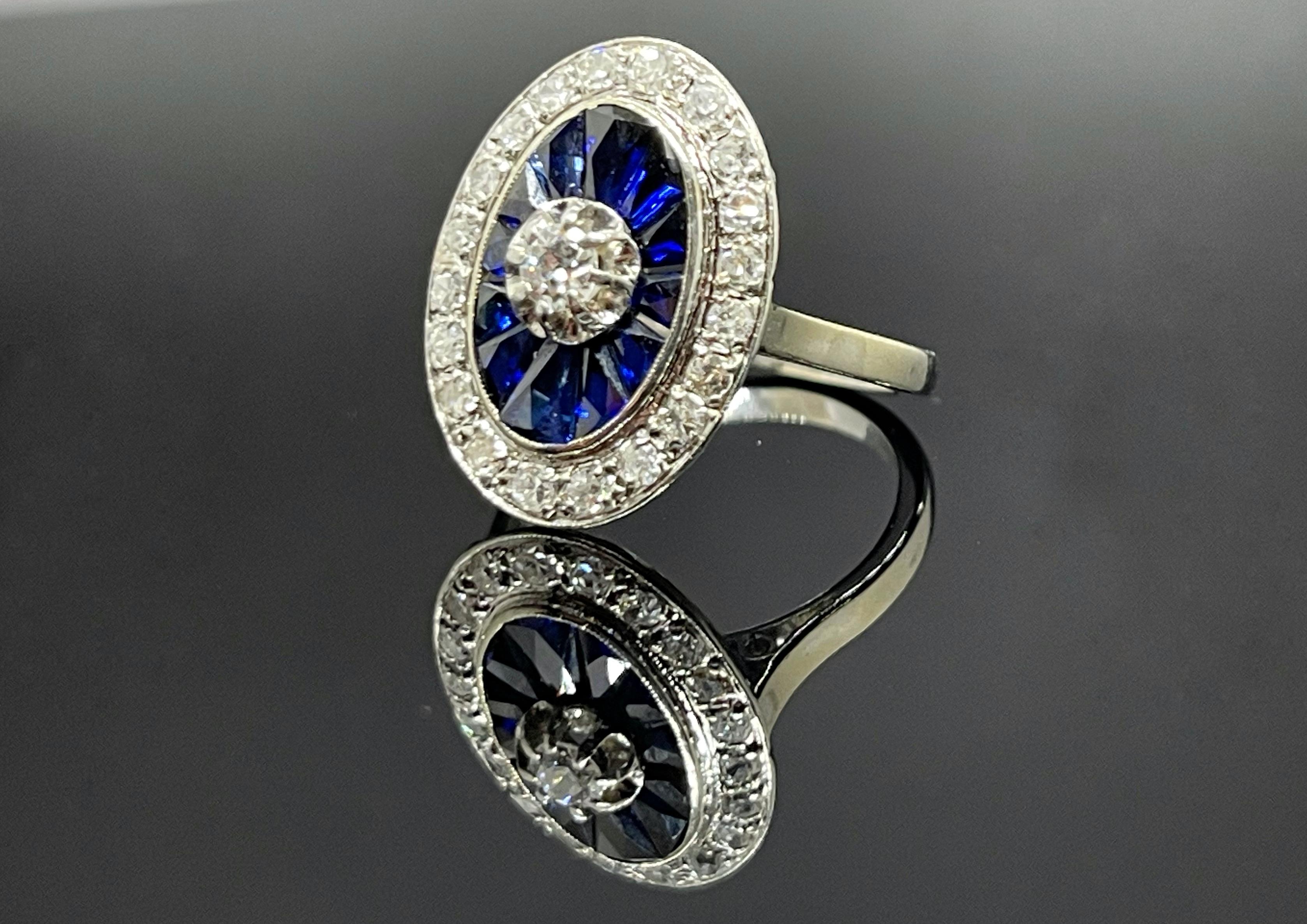 A beautiful Art Deco ring made of 18K white gold. With Royall Bleu Sapphires from Ceylon. It features 1.0 carat diamond approximately. 

The ring comes complete with a presentation box and our own certificate.

EU size: 52
US size: 6,5
Can be